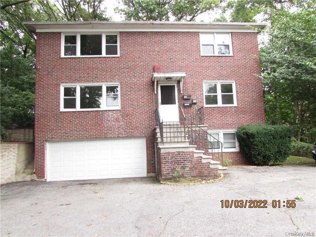 View of front of house featuring brick siding, an attached garage, and asphalt driveway View of front of house featuring brick siding, an attached garage, and asphalt driveway