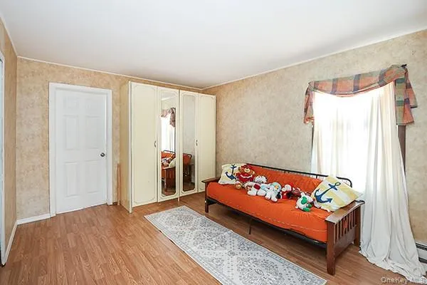 Bedroom with light wood-type flooring and a closet Bedroom with light wood-type flooring and a closet