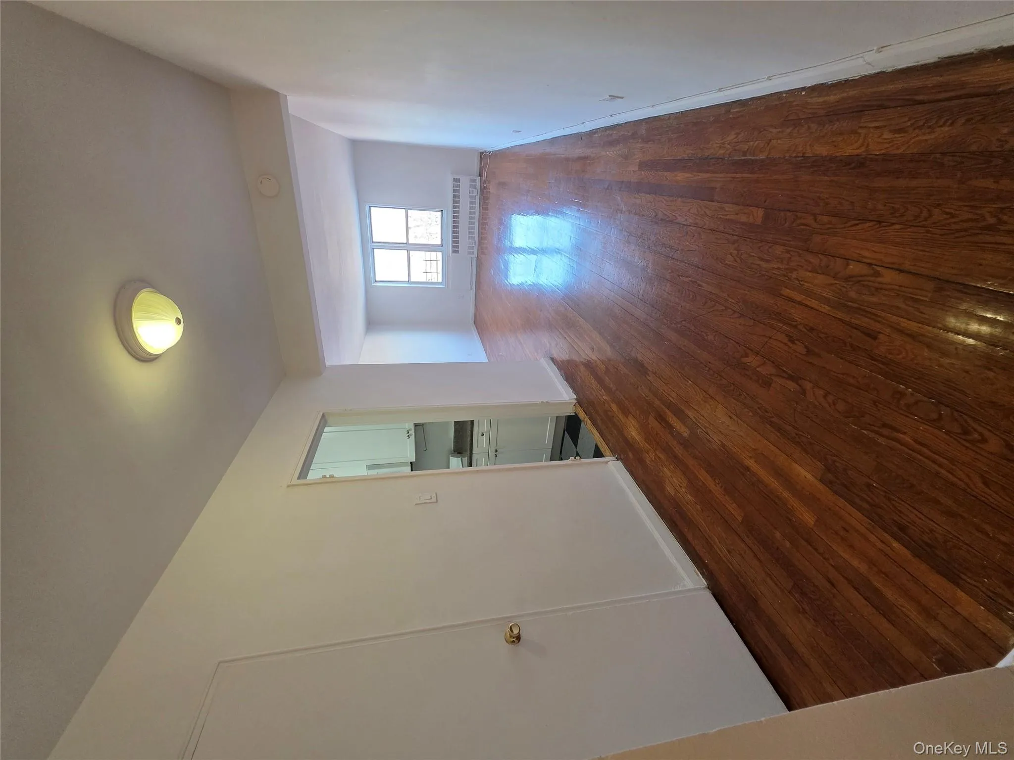Unfurnished room featuring dark wood-type flooring and radiator Unfurnished room featuring dark wood-type flooring and radiator