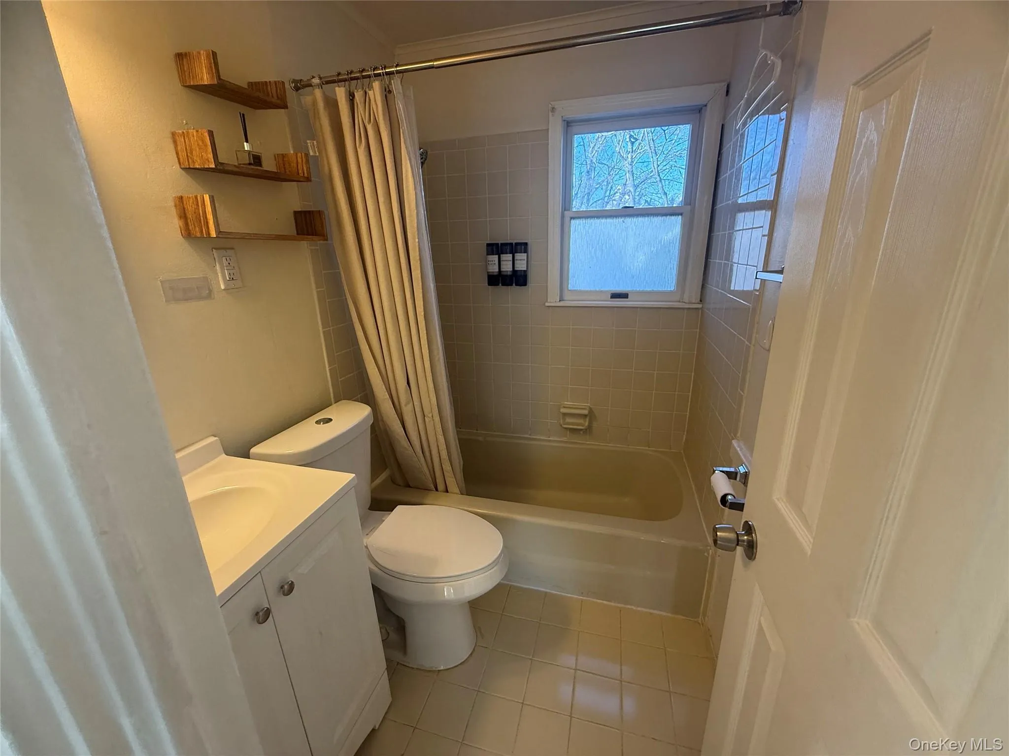 Full Bathroom on 2nd floor featuring shower / tub combo with curtain, vanity, and light tile patterned flooring Full Bathroom on 2nd floor featuring shower / tub combo with curtain, vanity, and light tile patterned flooring