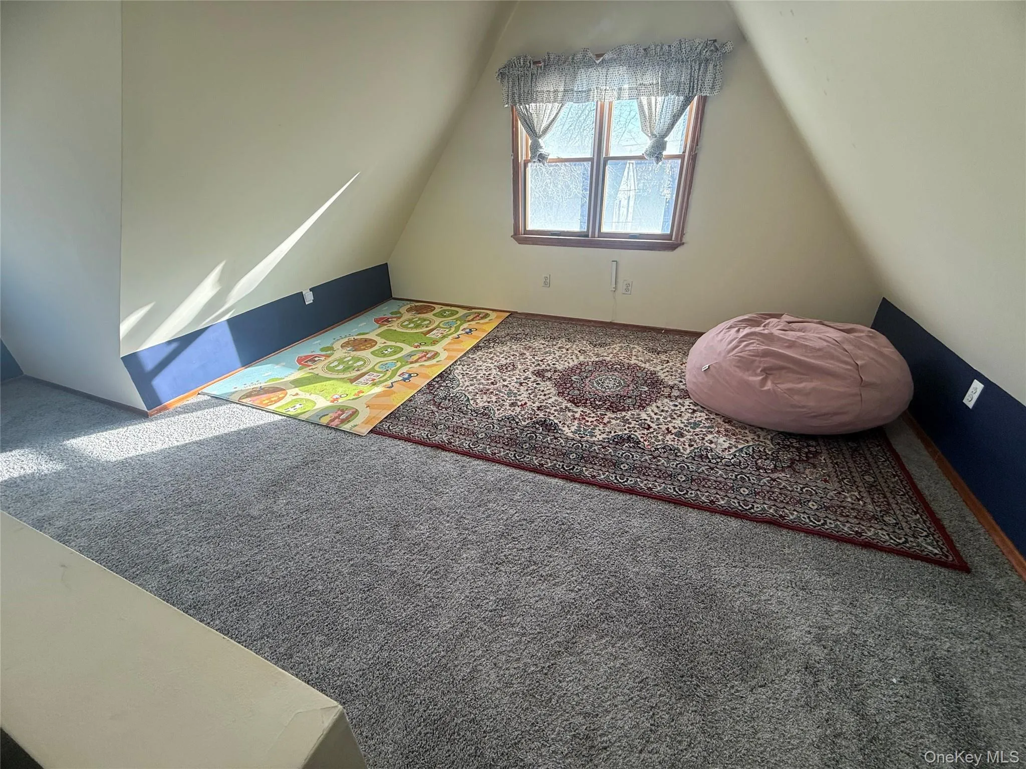 Bonus room with carpet and lofted ceiling Bonus room with carpet and lofted ceiling