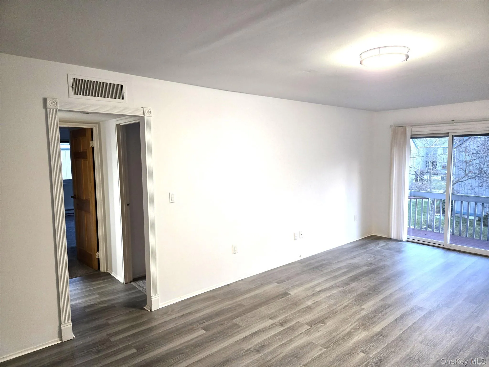 Unfurnished room featuring dark wood finished floors Unfurnished room featuring dark wood finished floors