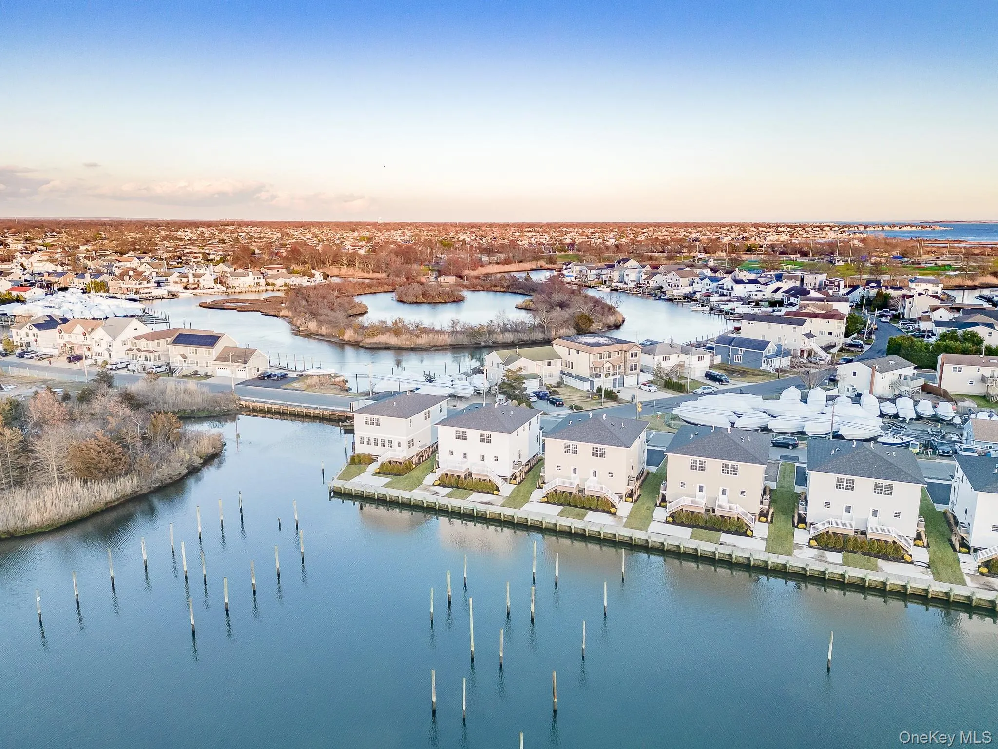 Aerial view at dusk of a water view and a residential view Aerial view at dusk of a water view and a residential view
