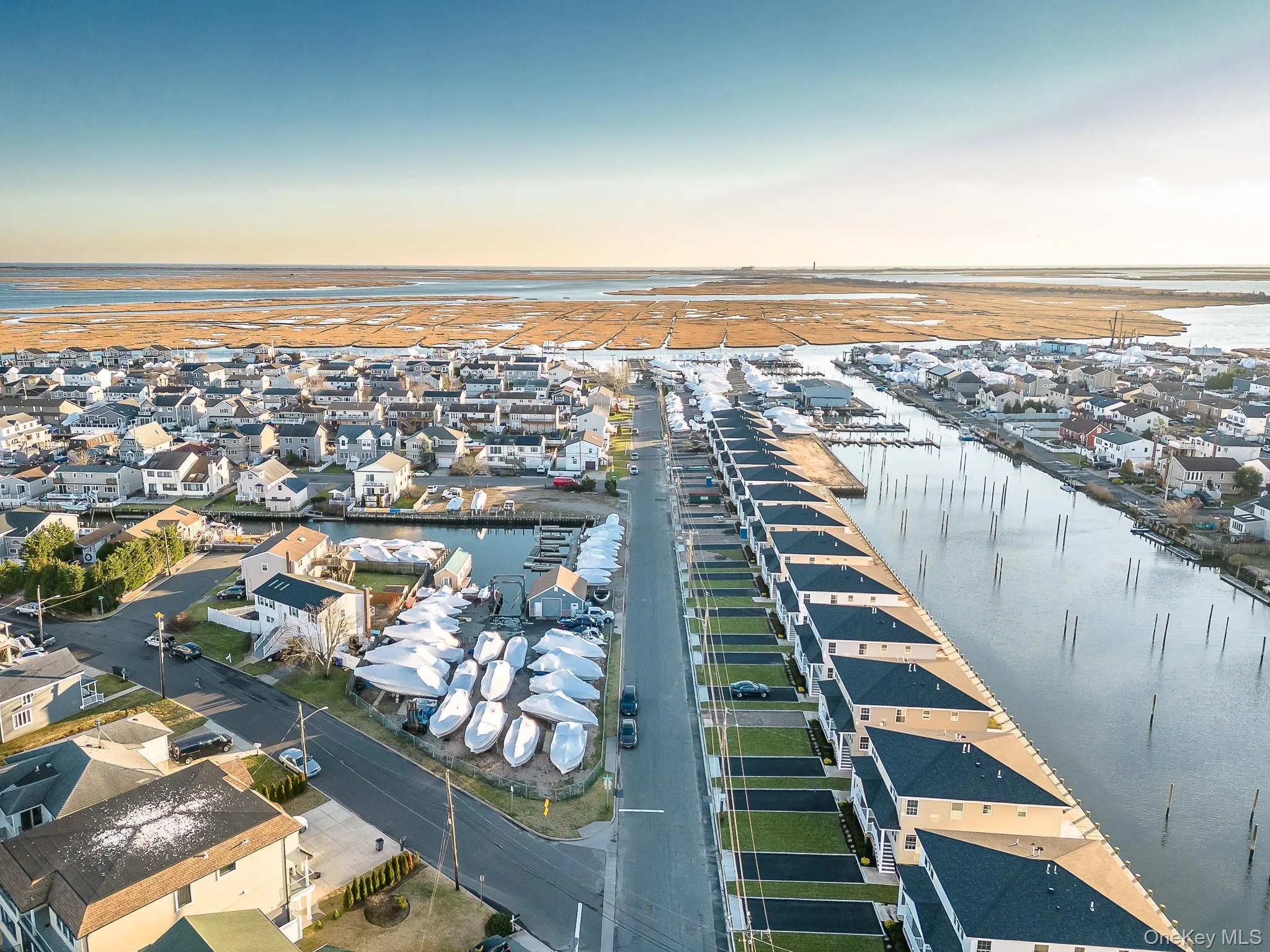 Aerial overview of property's location featuring nearby suburban area and a nearby body of water Aerial overview of property's location featuring nearby suburban area and a nearby body of water