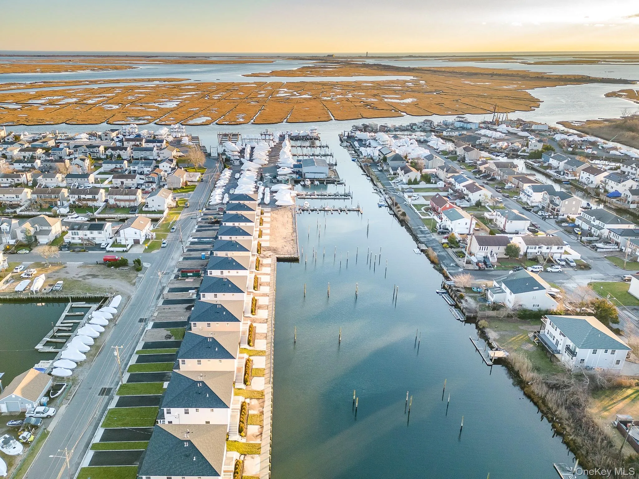 View of property location featuring a large body of water and nearby suburban area View of property location featuring a large body of water and nearby suburban area