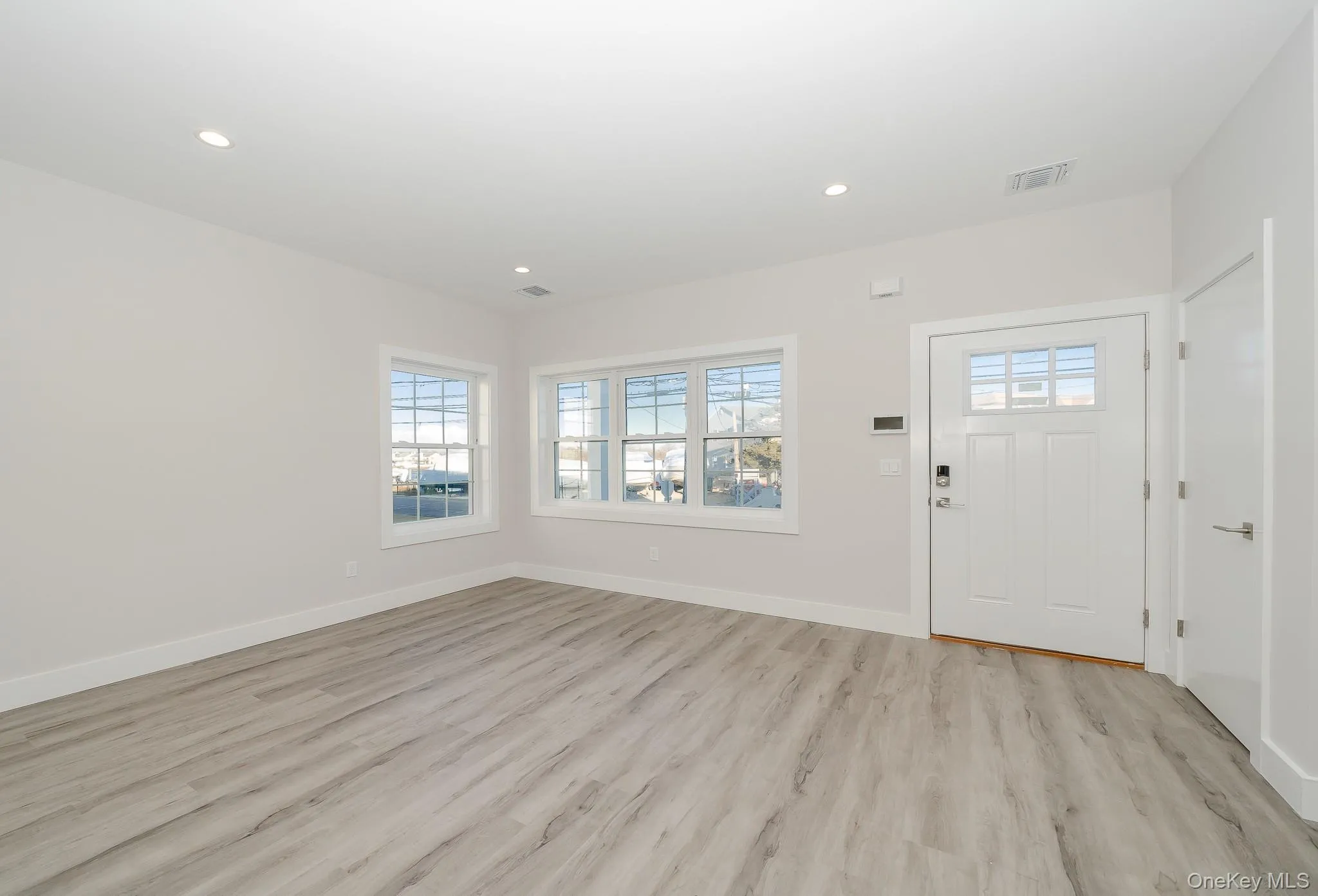 Entryway with light wood-type flooring and recessed lighting Entryway with light wood-type flooring and recessed lighting