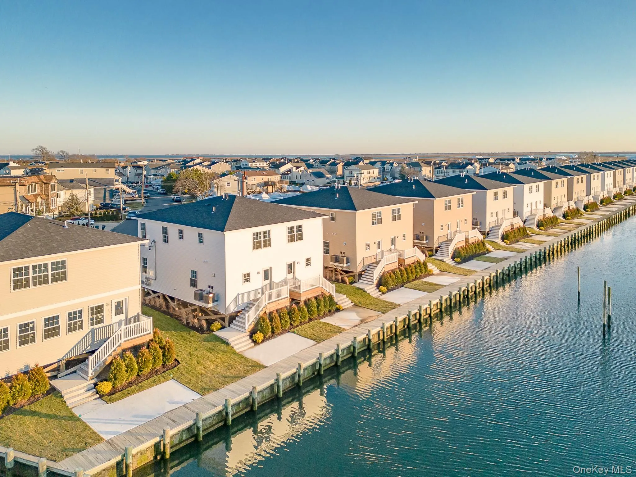 Aerial perspective of suburban area with a nearby body of water Aerial perspective of suburban area with a nearby body of water