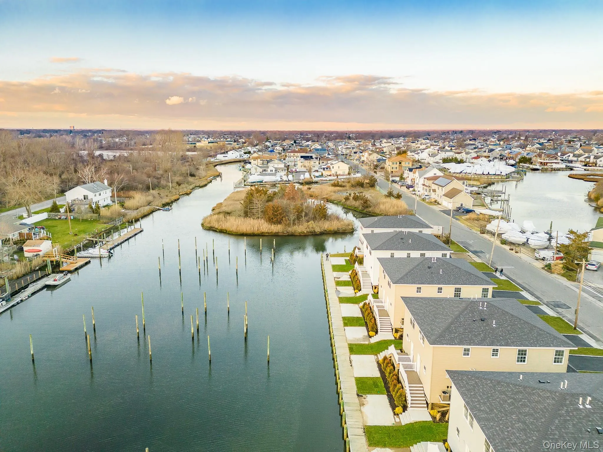 Aerial view at dusk of a water view and a residential view Aerial view at dusk of a water view and a residential view