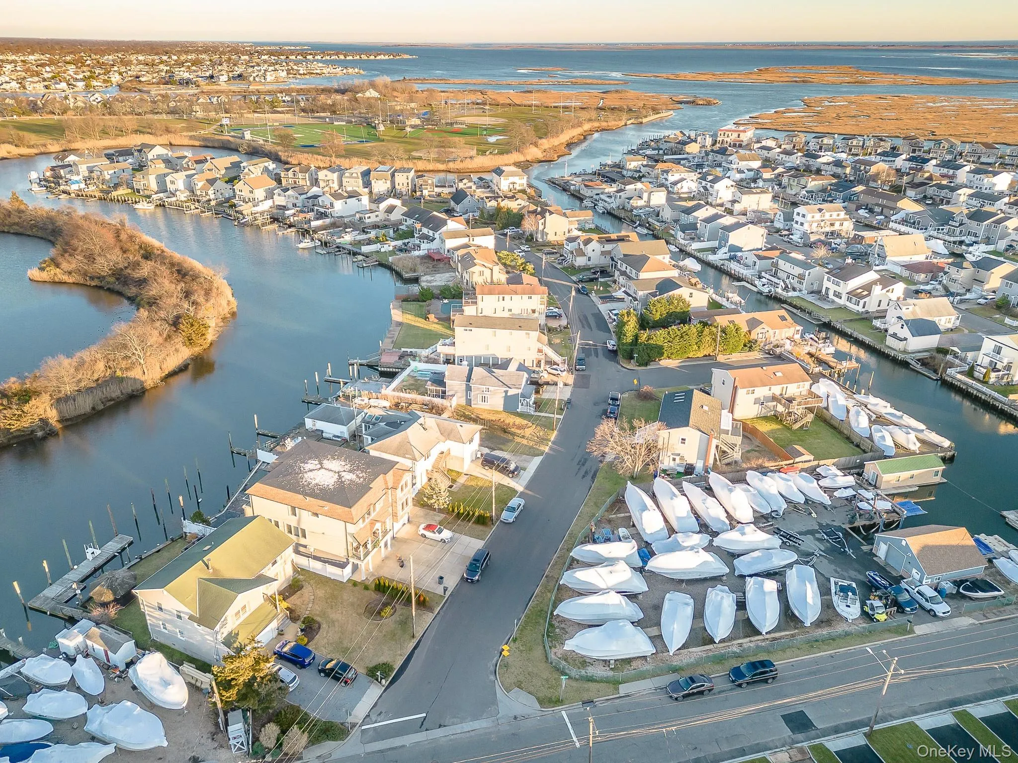 Aerial overview of property's location with a nearby body of water and nearby suburban area Aerial overview of property's location with a nearby body of water and nearby suburban area