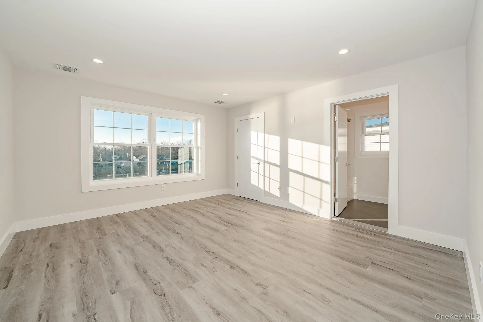 Spare room featuring plenty of natural light, light wood finished floors, and recessed lighting Spare room featuring plenty of natural light, light wood finished floors, and recessed lighting