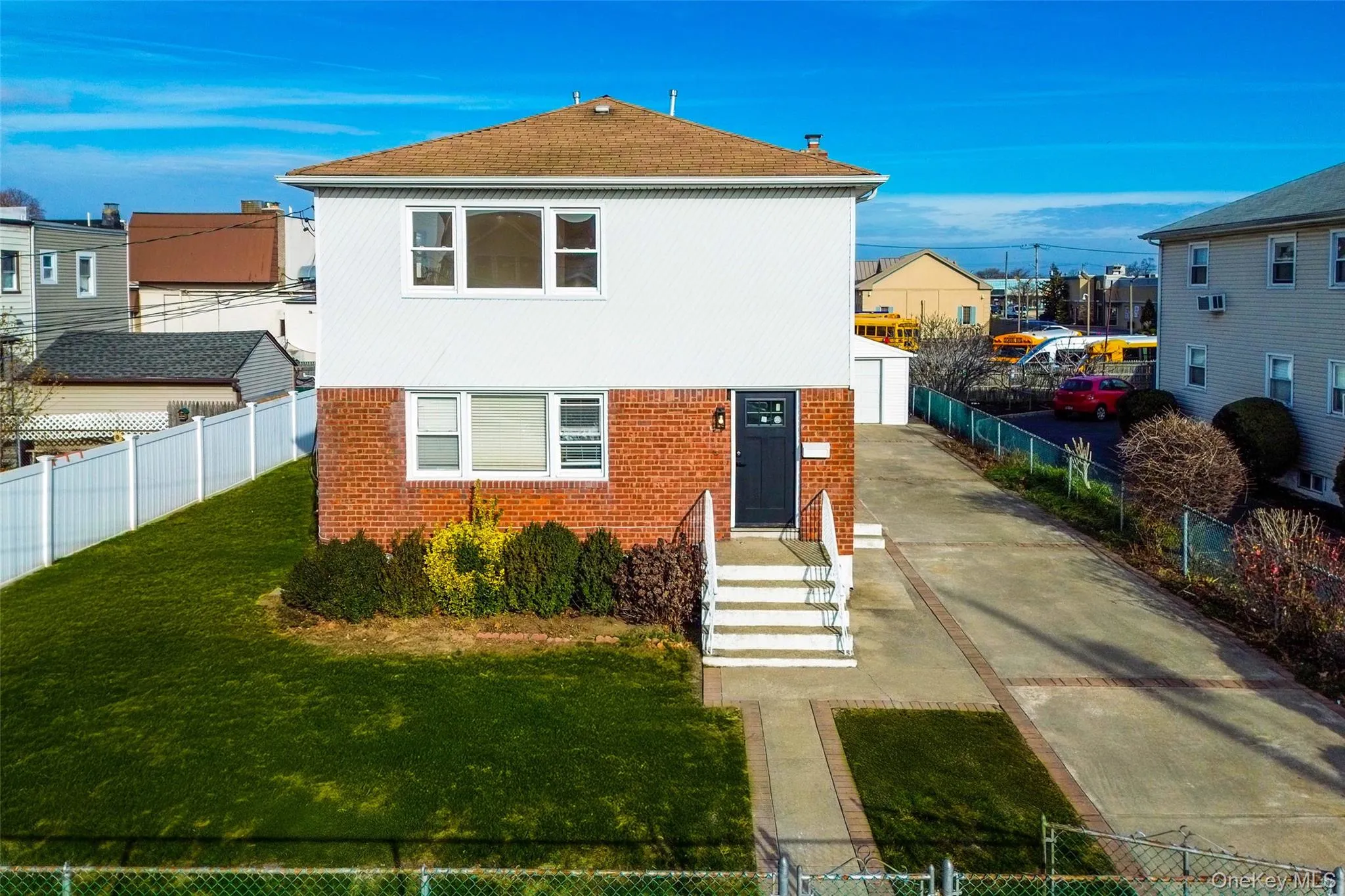 View of front facade featuring brick siding, concrete driveway, and a residential view View of front facade featuring brick siding, concrete driveway, and a residential view