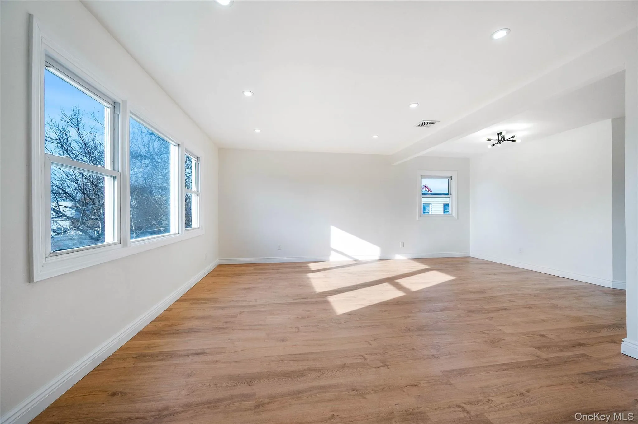 Unfurnished room featuring light wood-style floors and recessed lighting Unfurnished room featuring light wood-style floors and recessed lighting