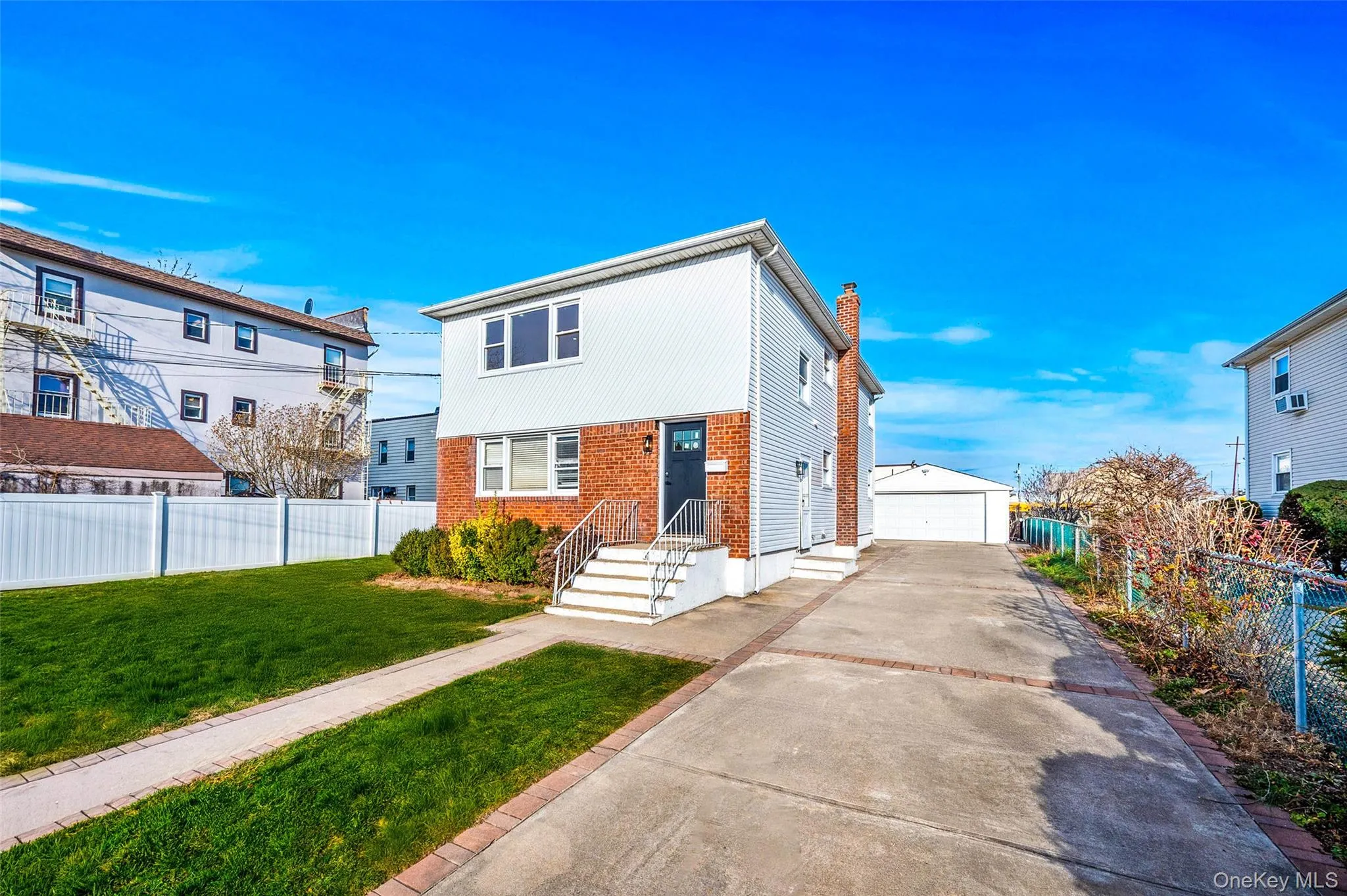 View of front of property featuring an outbuilding, a garage, brick siding, and a chimney View of front of property featuring an outbuilding, a garage, brick siding, and a chimney
