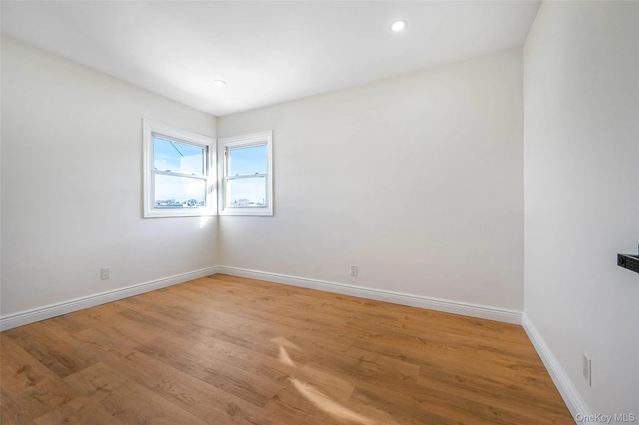 Spare room with wood finished floors and recessed lighting Spare room with wood finished floors and recessed lighting