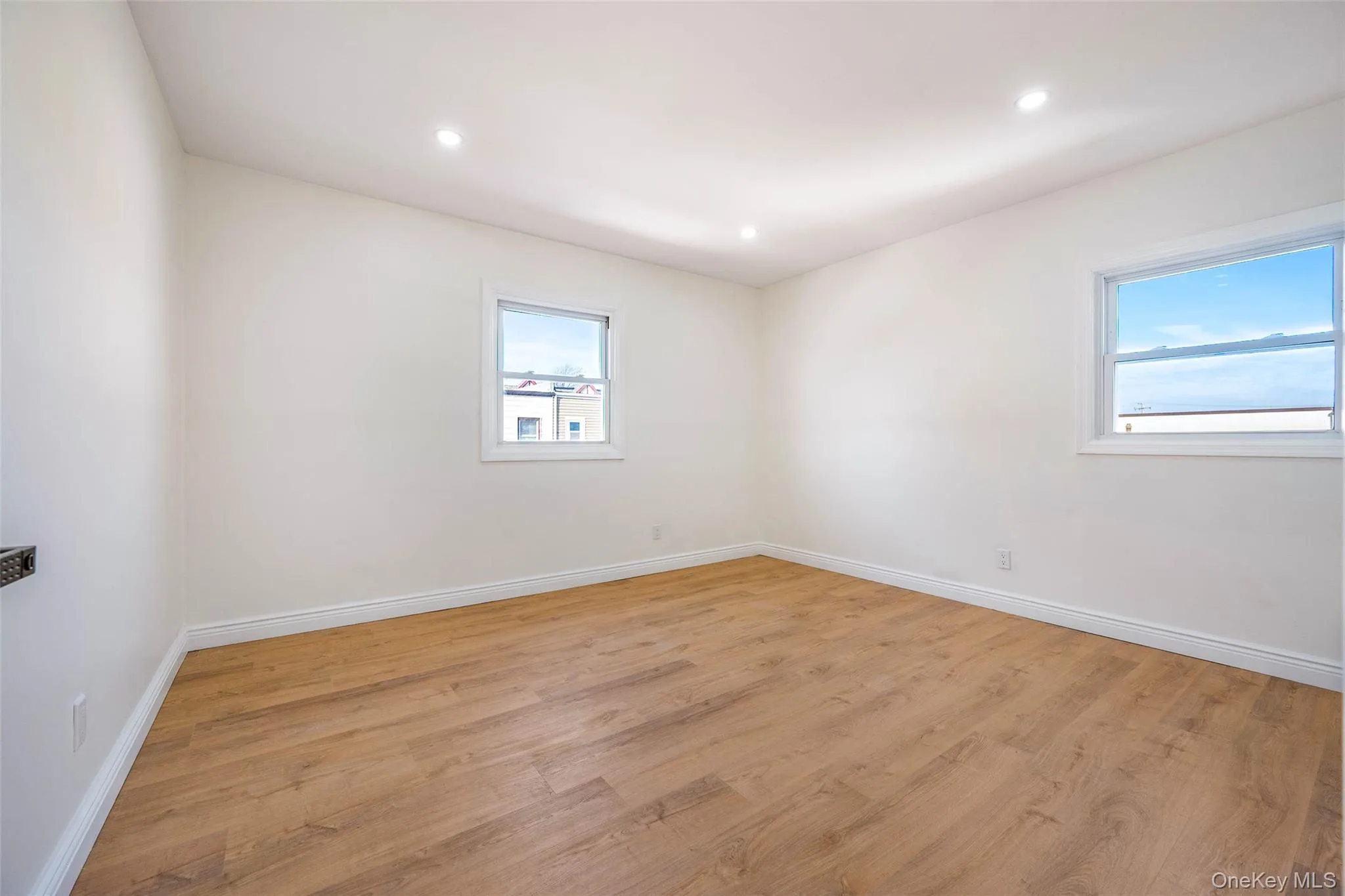 Unfurnished room featuring light wood-style floors and recessed lighting Unfurnished room featuring light wood-style floors and recessed lighting