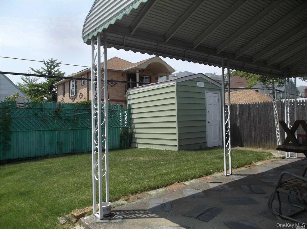 Fenced backyard with a storage shed Fenced backyard with a storage shed