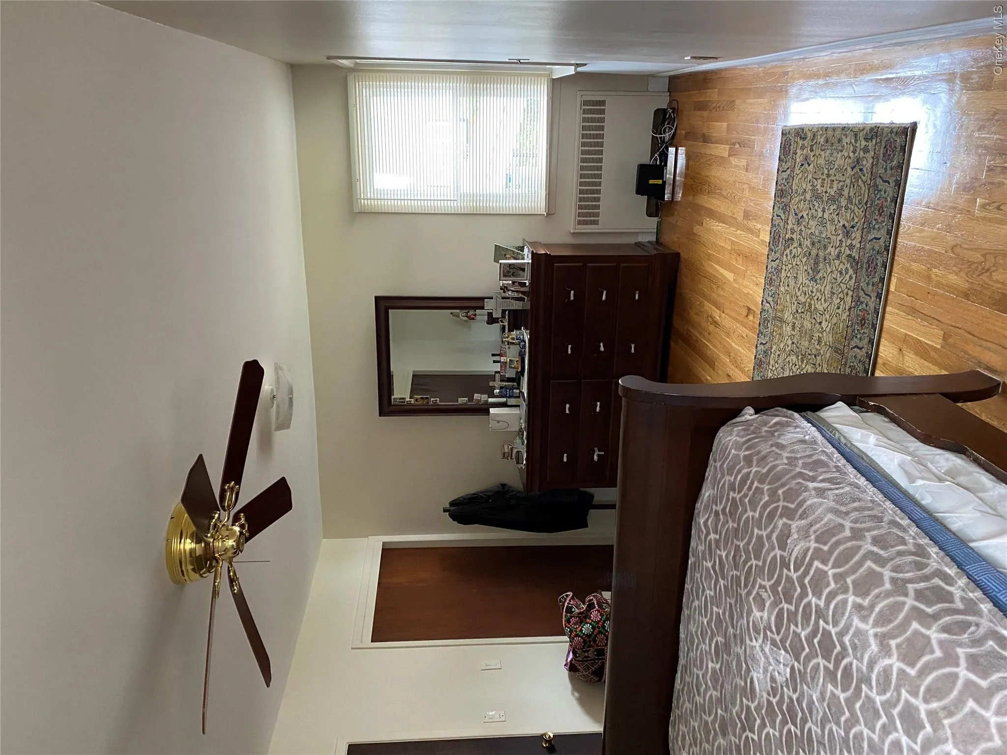 Bedroom with radiator, light wood finished floors, a ceiling fan, and a closet Bedroom with radiator, light wood finished floors, a ceiling fan, and a closet