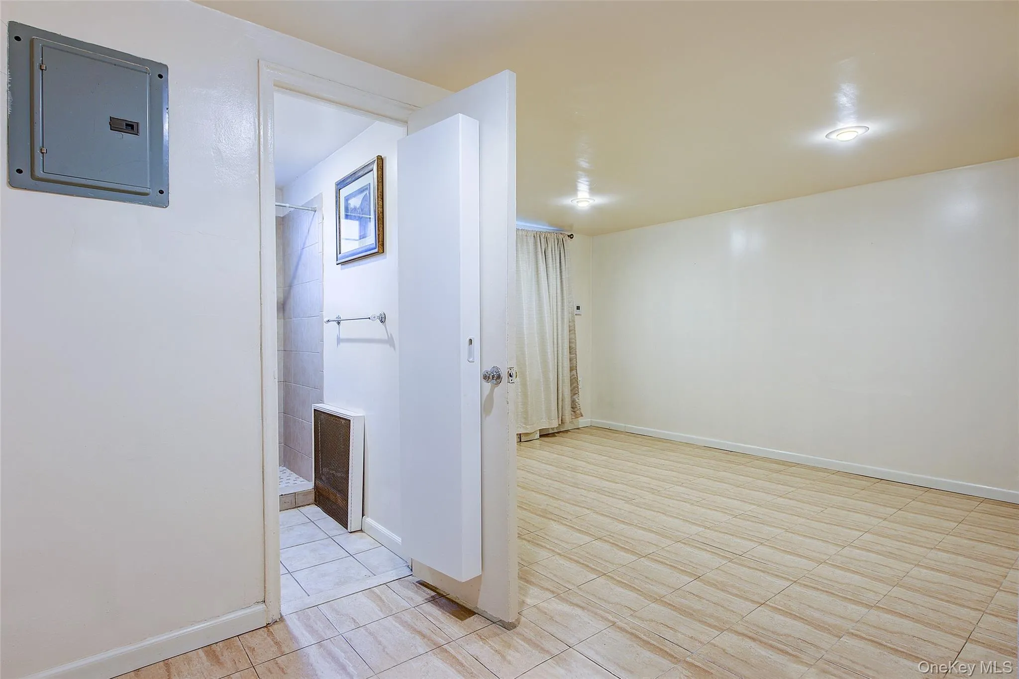 Hallway featuring electric panel and baseboards Hallway featuring electric panel and baseboards