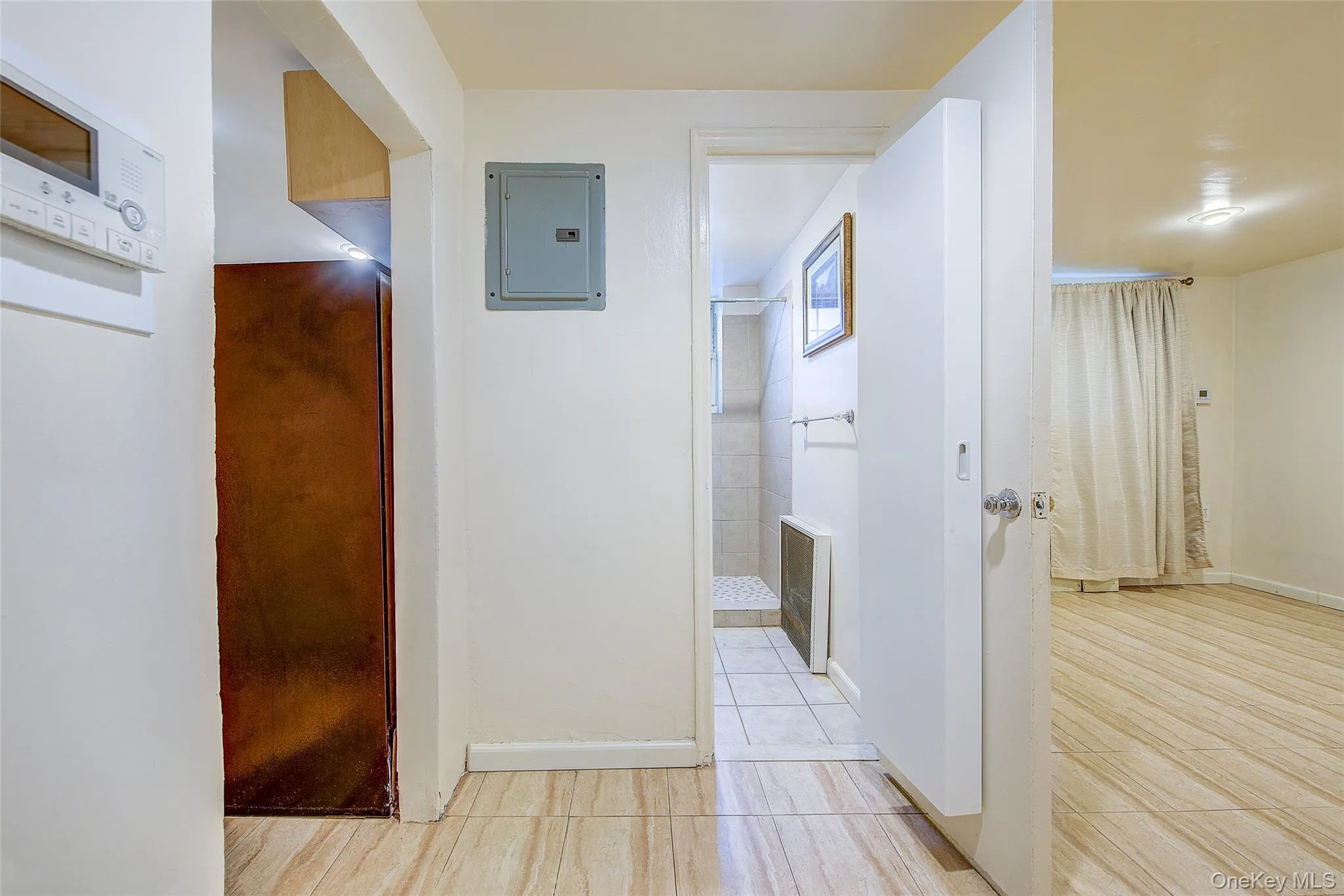 Hall with electric panel and wood tiled floors Hall with electric panel and wood tiled floors