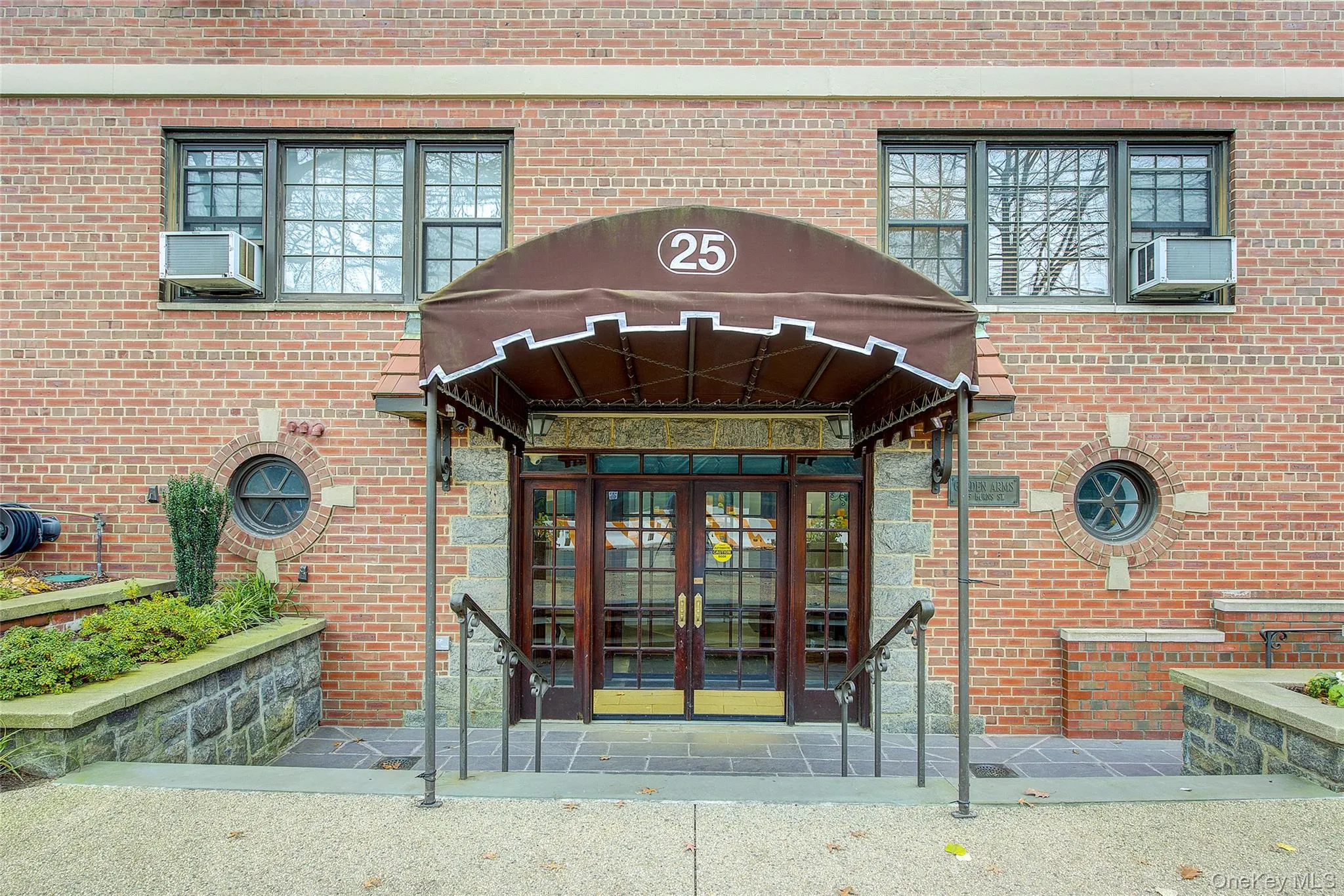 Entrance to property featuring french doors and brick siding Entrance to property featuring french doors and brick siding