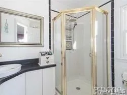 Bathroom featuring vanity and a shower stall Bathroom featuring vanity and a shower stall