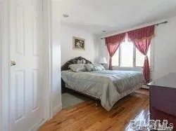 Bedroom featuring wood finished floors Bedroom featuring wood finished floors