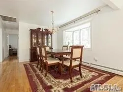 Dining area featuring wood finished floors, a chandelier, and beam ceiling Dining area featuring wood finished floors, a chandelier, and beam ceiling