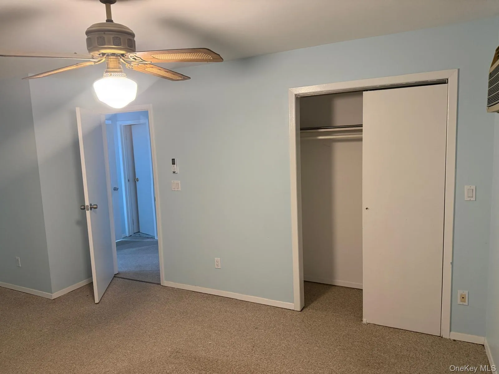 Unfurnished bedroom featuring light colored carpet, a ceiling fan, and a closet Unfurnished bedroom featuring light colored carpet, a ceiling fan, and a closet