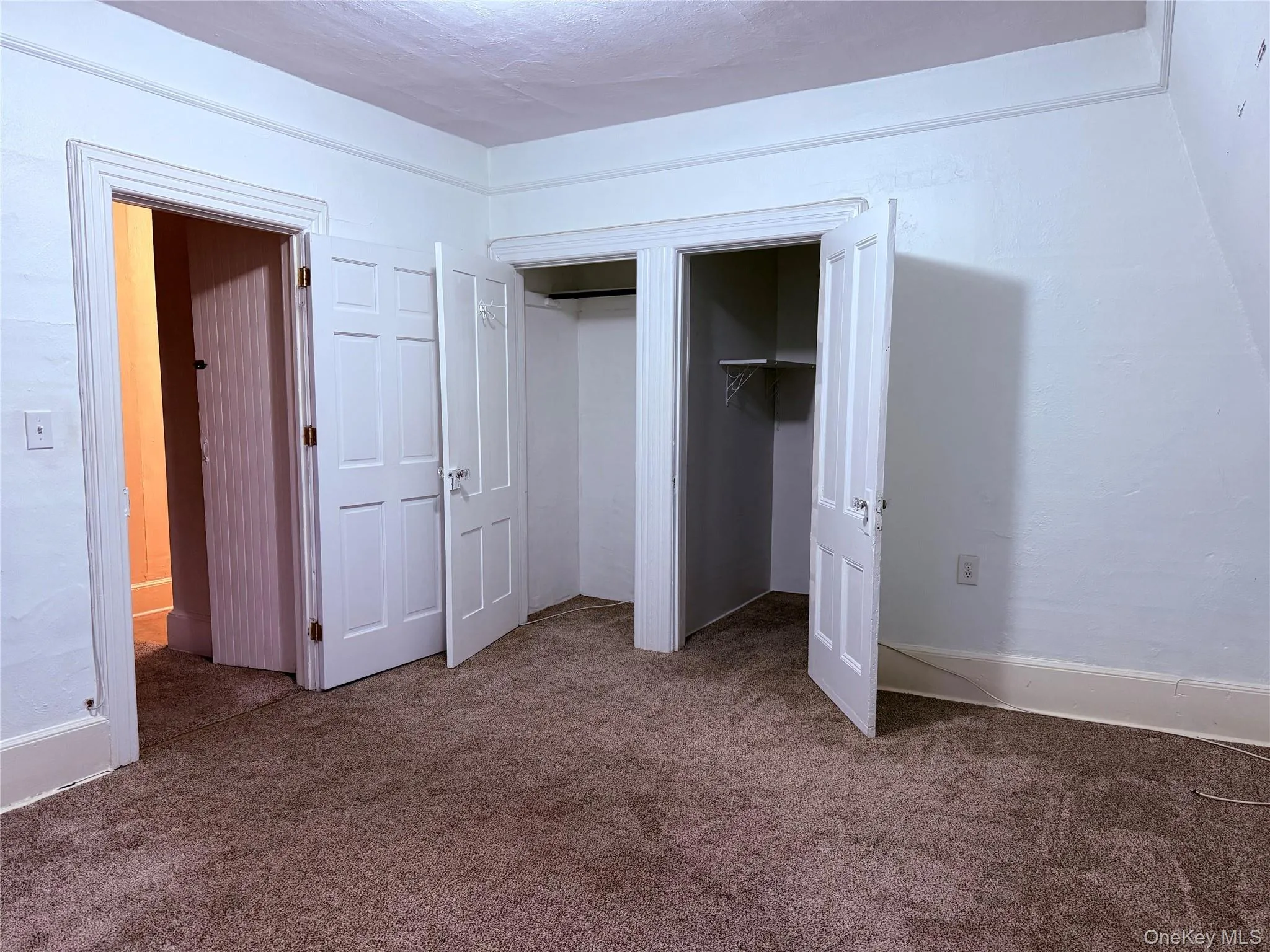 Primary bedroom looking toward the living room and walk-in closet. Primary bedroom looking toward the living room and walk-in closet.