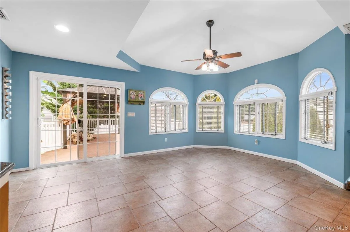 Empty room with baseboards and a ceiling fan Empty room with baseboards and a ceiling fan
