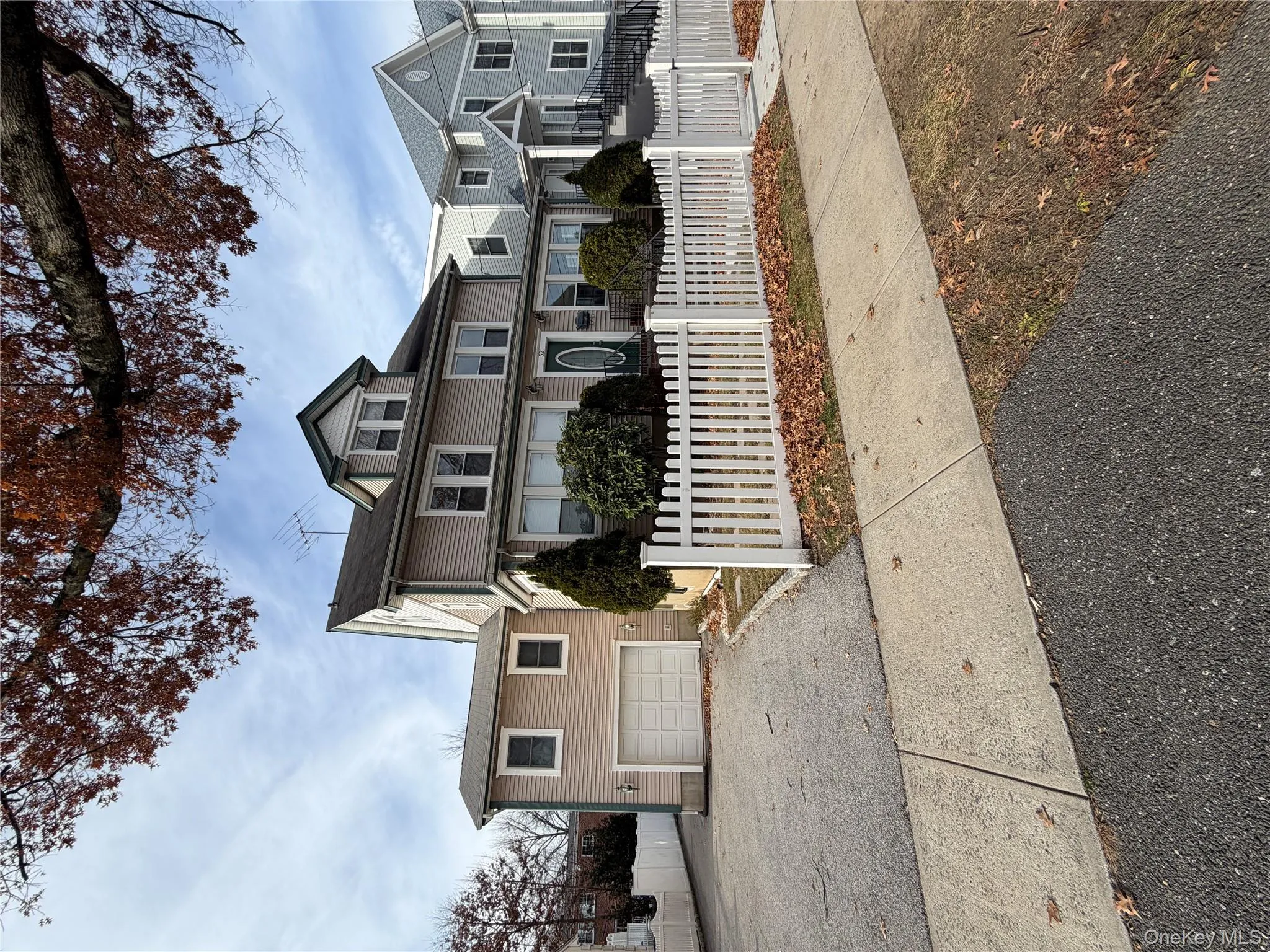 View of front of property with a fenced front yard, driveway, and an attached garage View of front of property with a fenced front yard, driveway, and an attached garage
