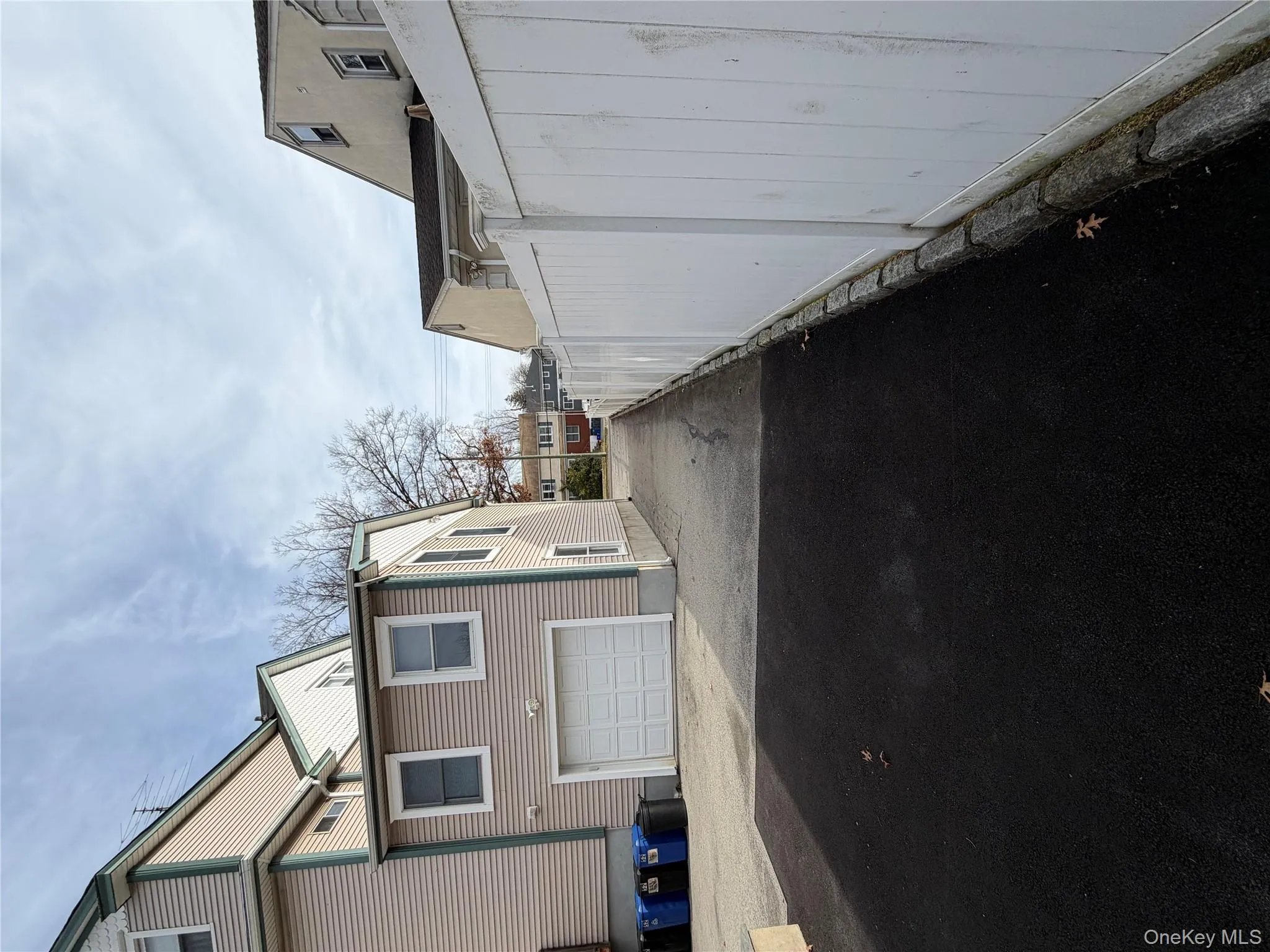 View of side of home with driveway, a garage, and a residential view View of side of home with driveway, a garage, and a residential view