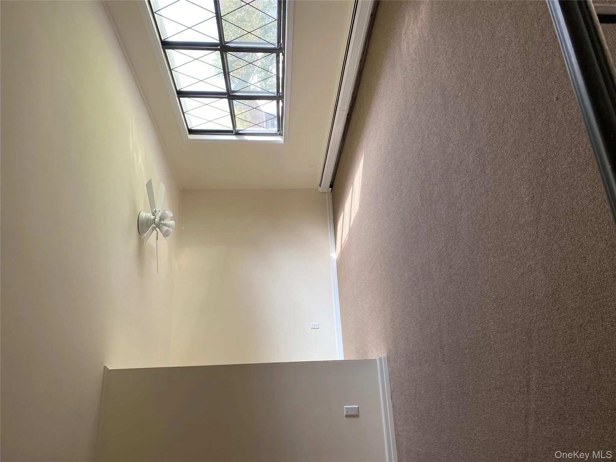 Empty room with a baseboard heating unit and carpet Empty room with a baseboard heating unit and carpet