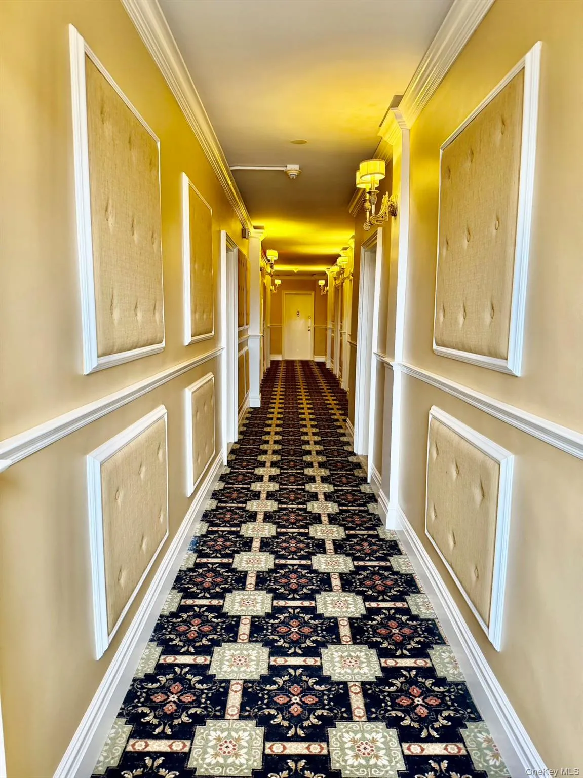 Hallway with crown molding and a decorative wall Hallway with crown molding and a decorative wall