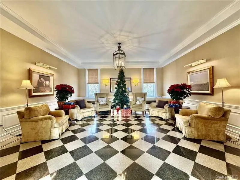 Building lobby with wainscoting, a decorative wall, and ornamental molding Building lobby with wainscoting, a decorative wall, and ornamental molding