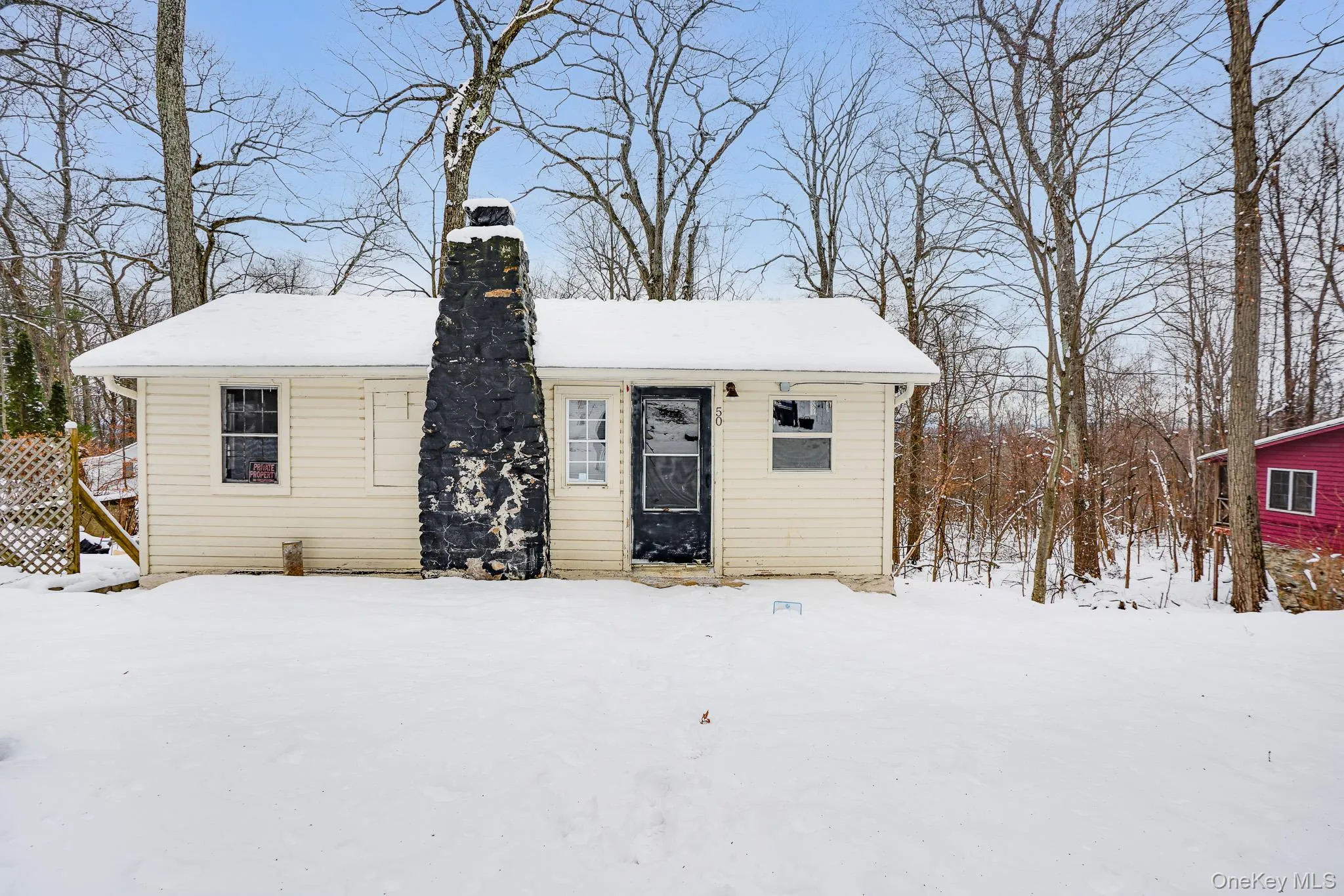 Bungalow-style home featuring a chimney Bungalow-style home featuring a chimney