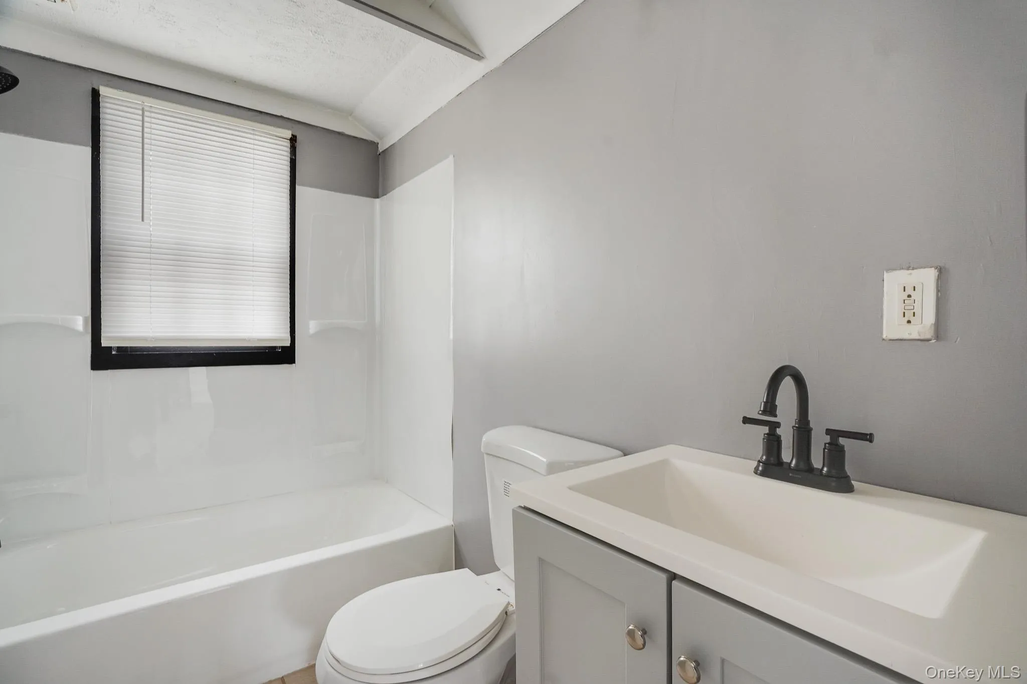 Bathroom with vanity and washtub / shower combination Bathroom with vanity and washtub / shower combination