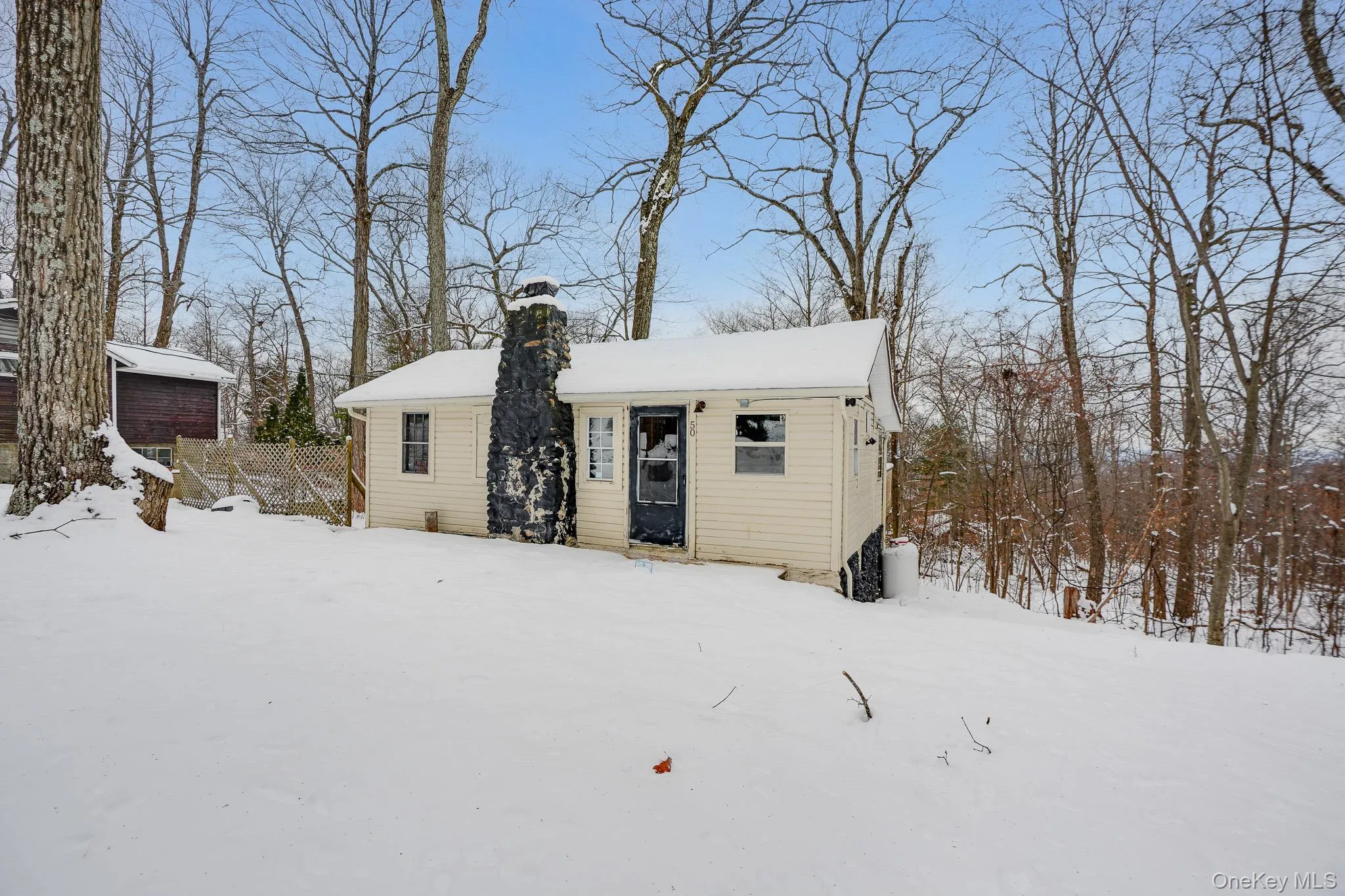 View of front of property featuring a chimney and an outbuilding View of front of property featuring a chimney and an outbuilding