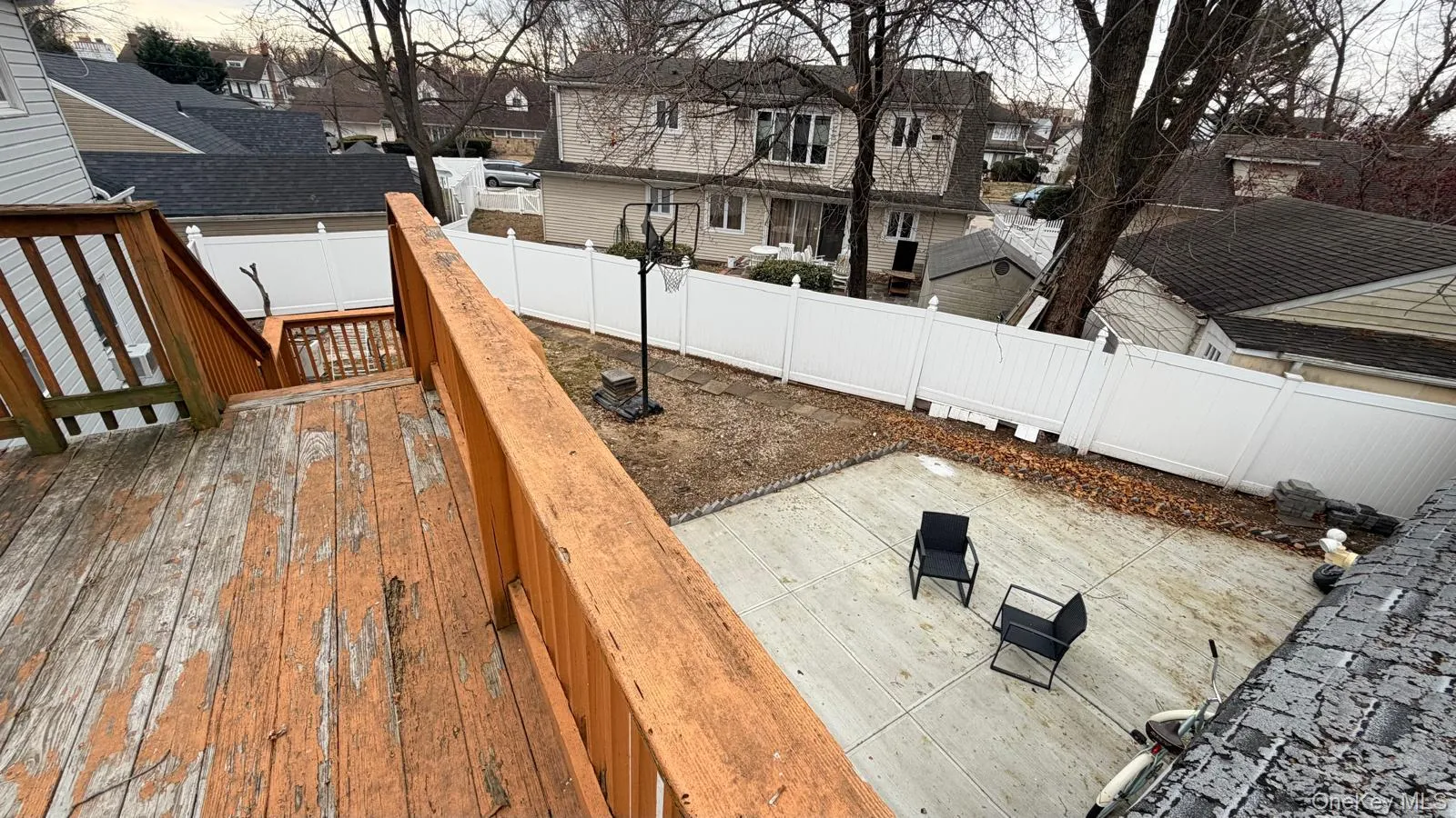 Wooden terrace featuring a fenced backyard and a residential view Wooden terrace featuring a fenced backyard and a residential view