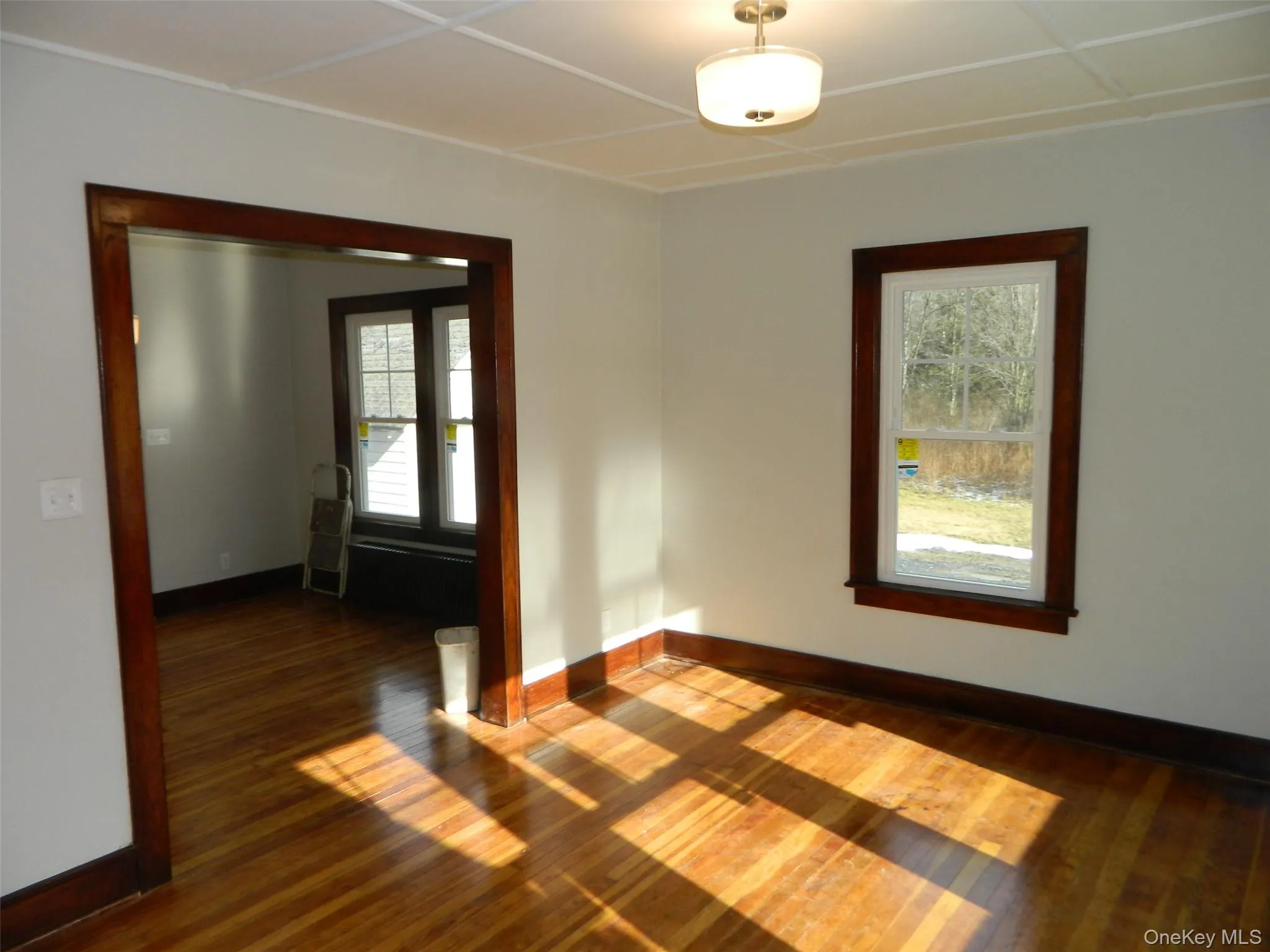 Empty room featuring dark wood finished floors and baseboards Empty room featuring dark wood finished floors and baseboards