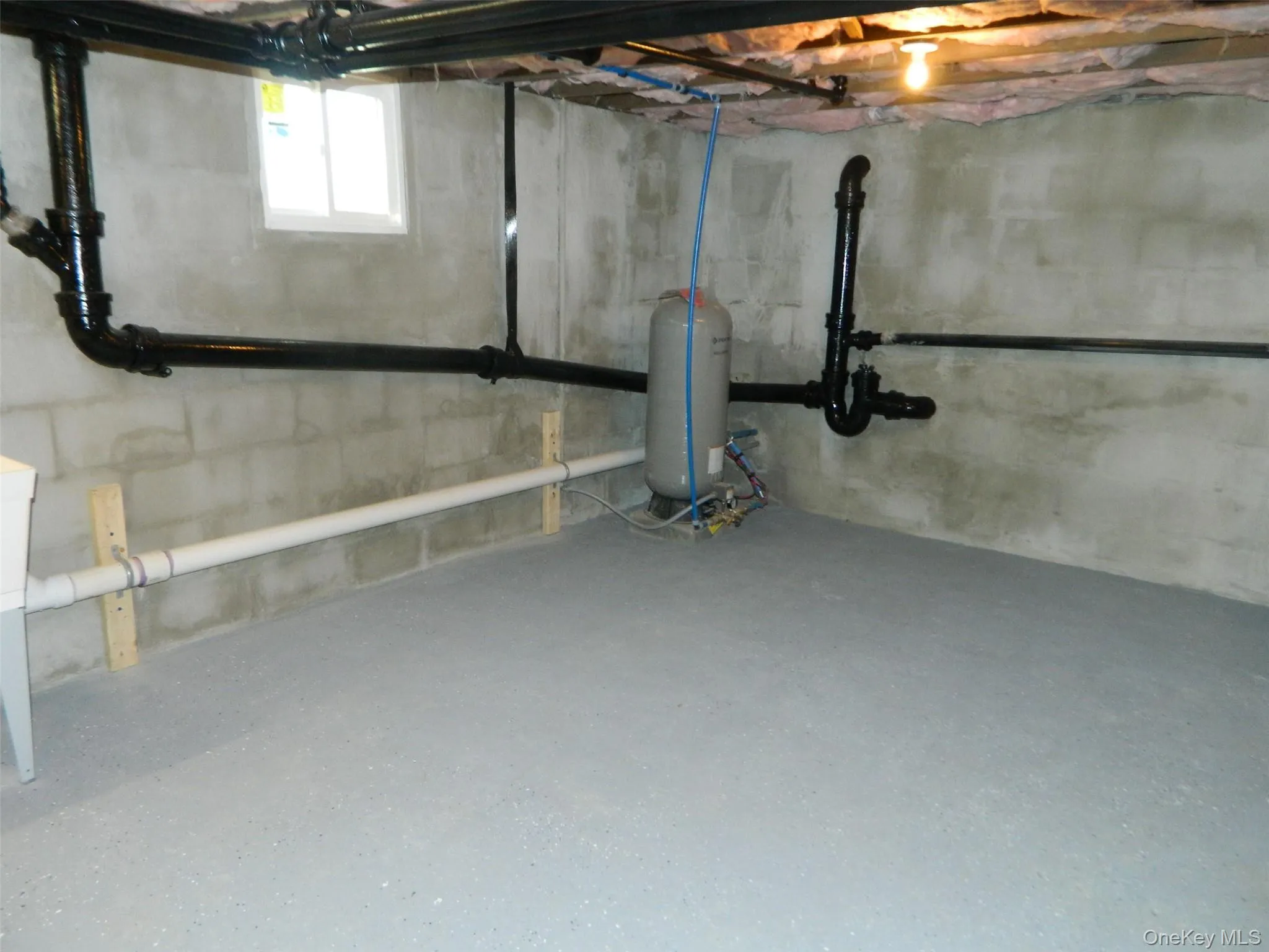 Below grade area with a water pressure tank Below grade area with a water pressure tank