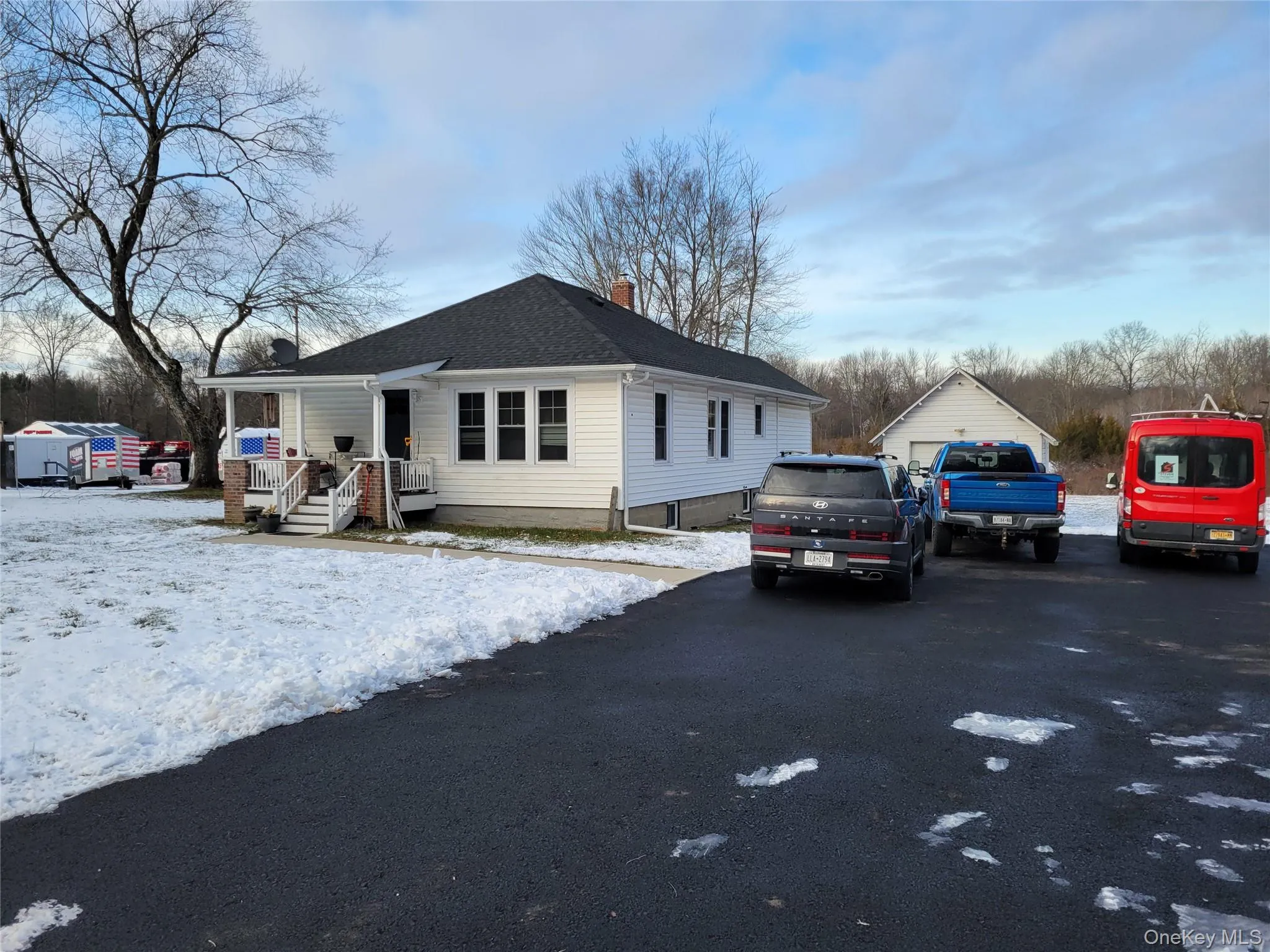View of front of home with a chimney and a shingled roof View of front of home with a chimney and a shingled roof