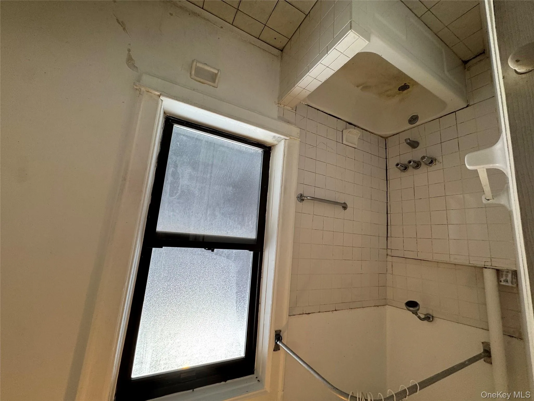 Bathroom featuring shower combination and tile patterned floors Bathroom featuring shower combination and tile patterned floors