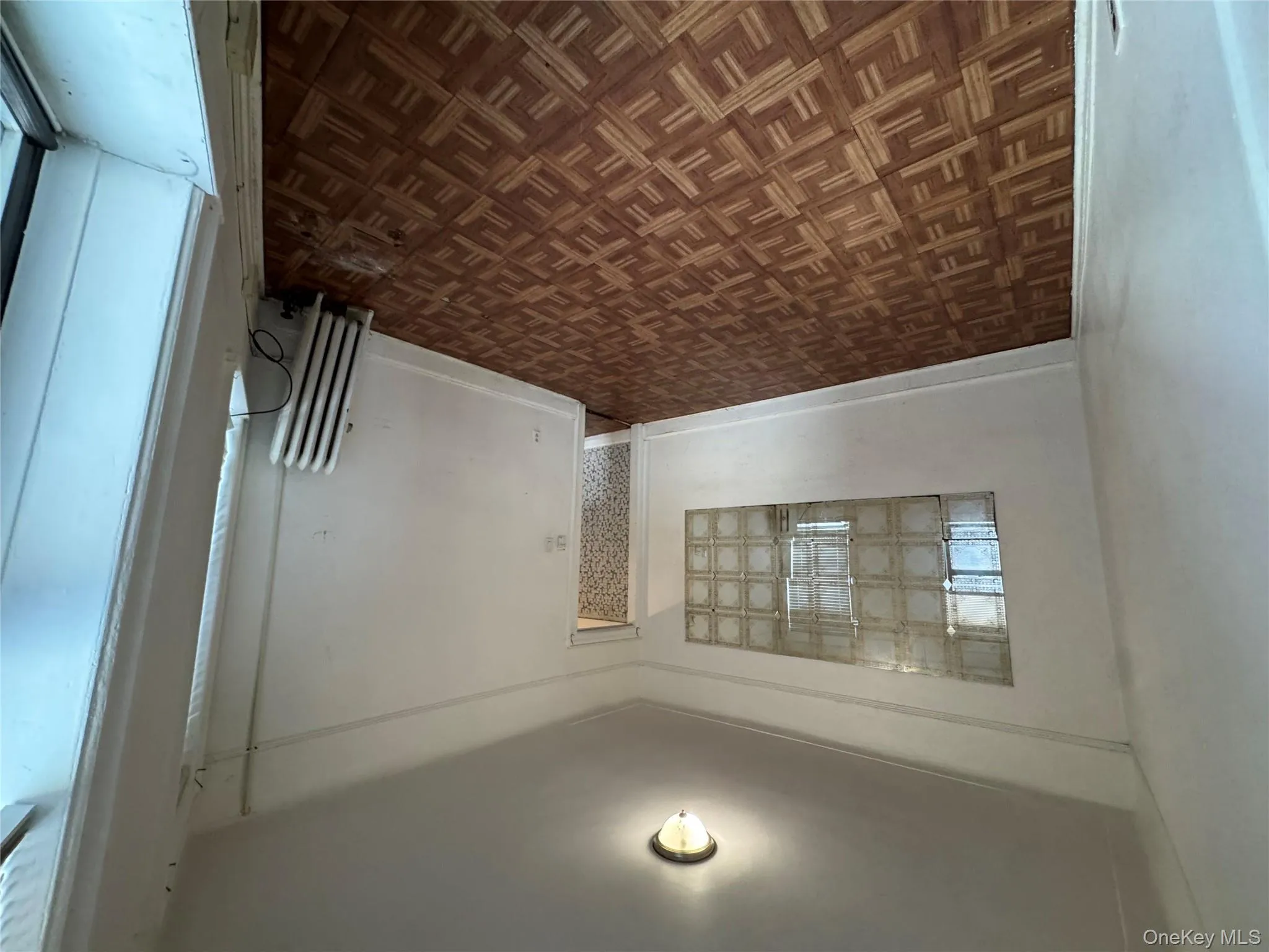 Empty room with radiator and baseboards Empty room with radiator and baseboards