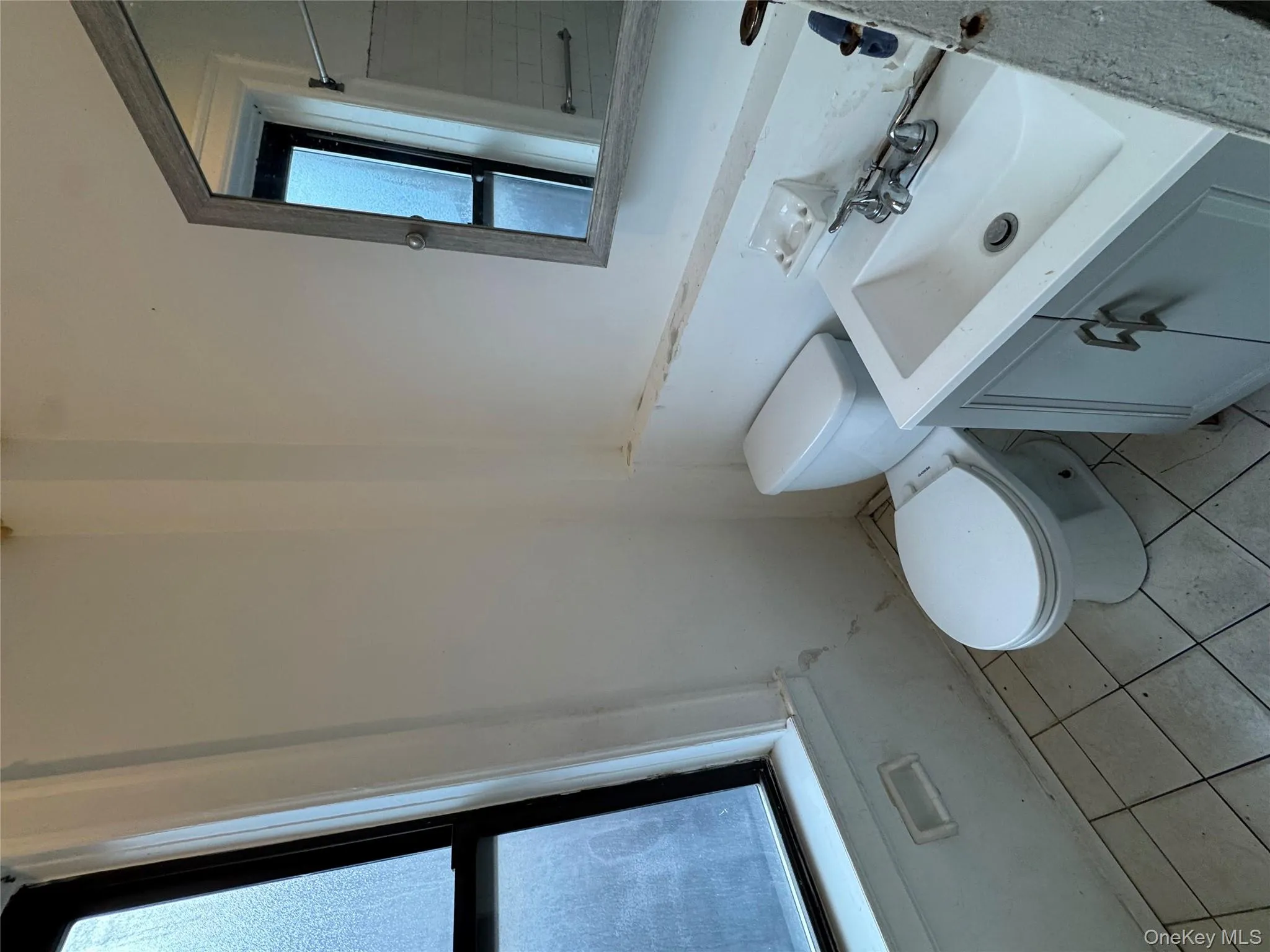 Bathroom with vanity and light tile patterned floors Bathroom with vanity and light tile patterned floors