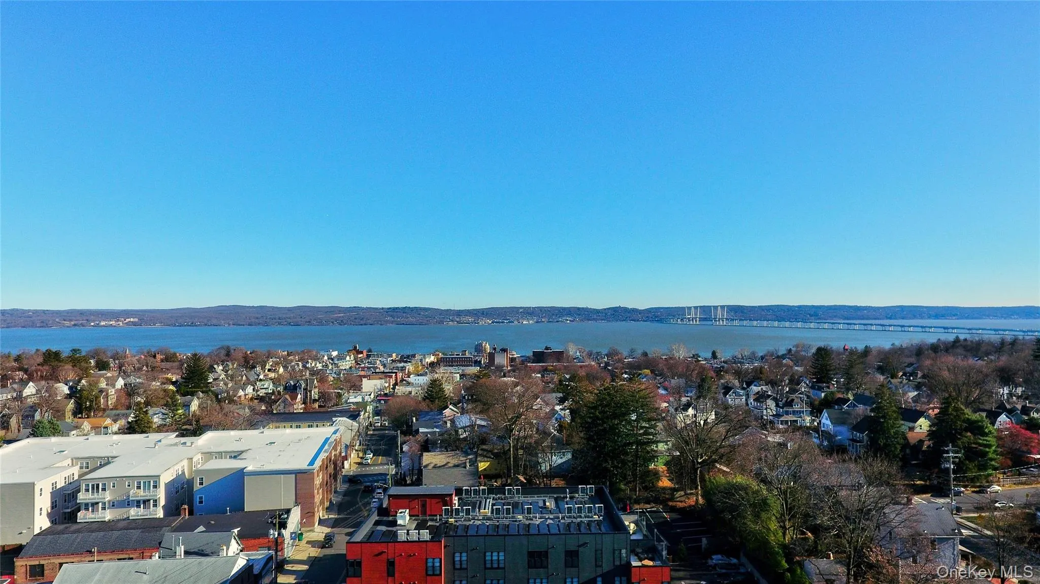 Aerial perspective of suburban area featuring a nearby body of water Aerial perspective of suburban area featuring a nearby body of water