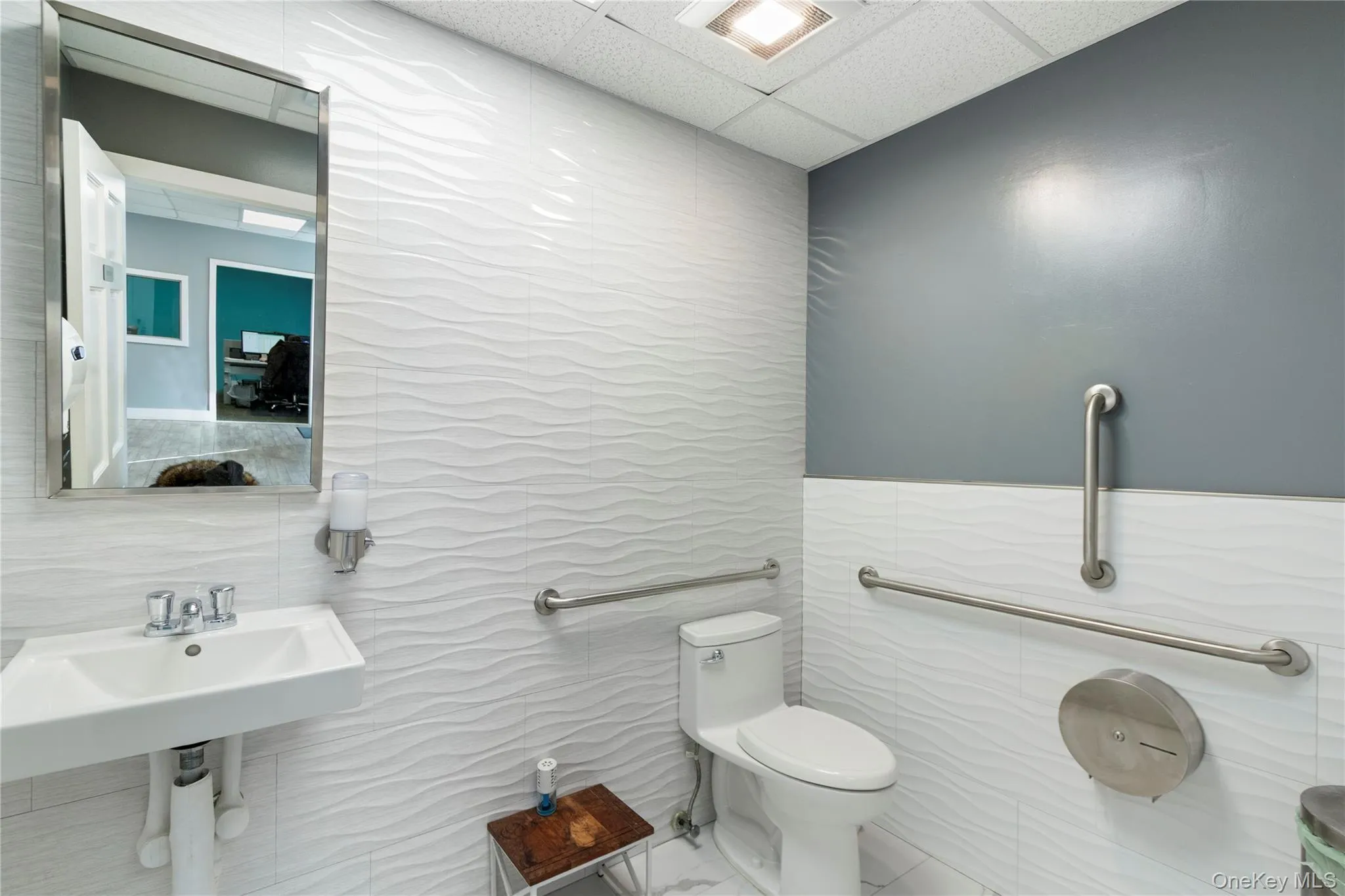 Bathroom with a paneled ceiling and tile walls Bathroom with a paneled ceiling and tile walls