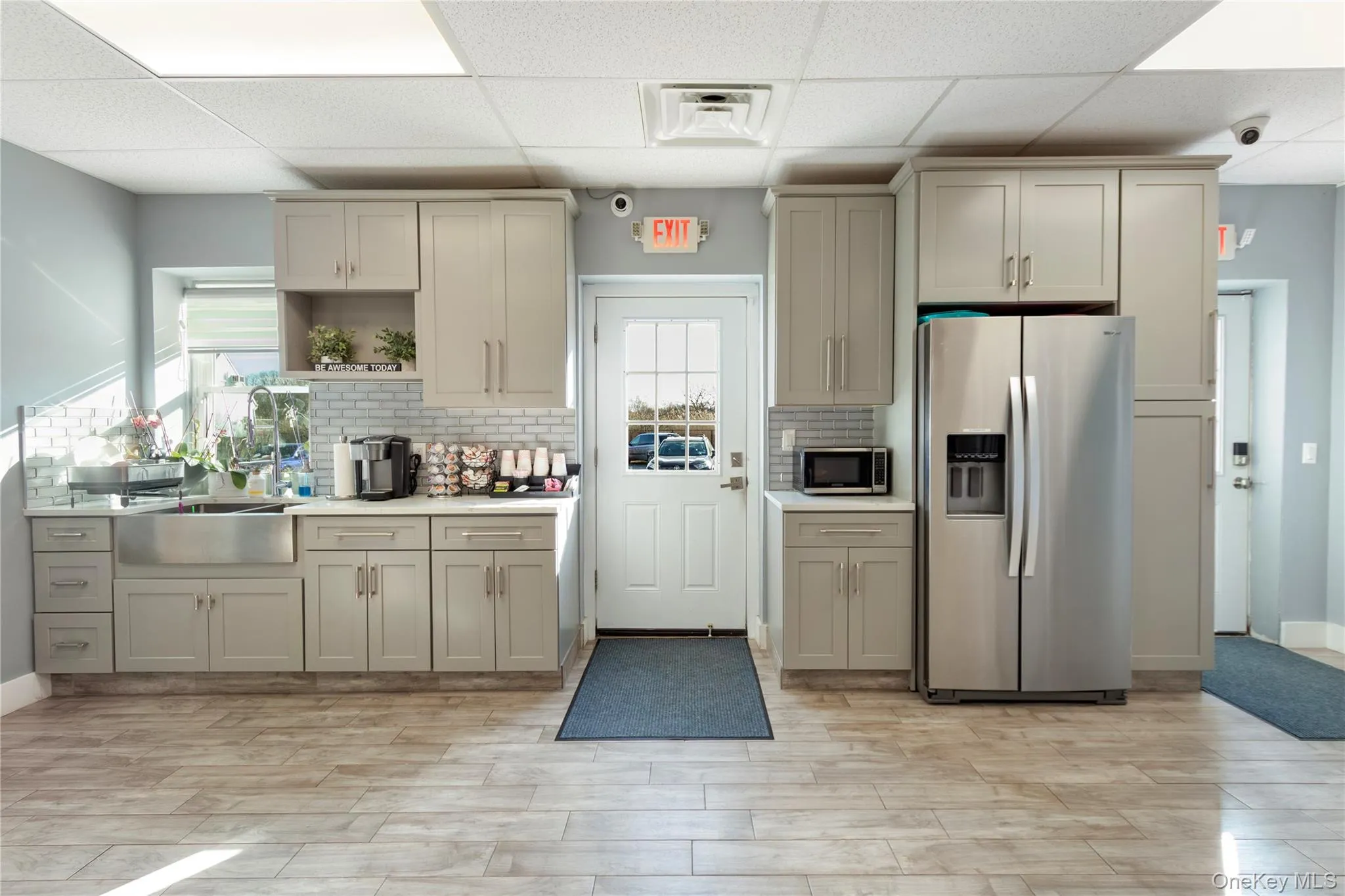 Kitchen featuring appliances with stainless steel finishes, open shelves, gray cabinets, a drop ceiling, and cream cabinets Kitchen featuring appliances with stainless steel finishes, open shelves, gray cabinets, a drop ceiling, and cream cabinets