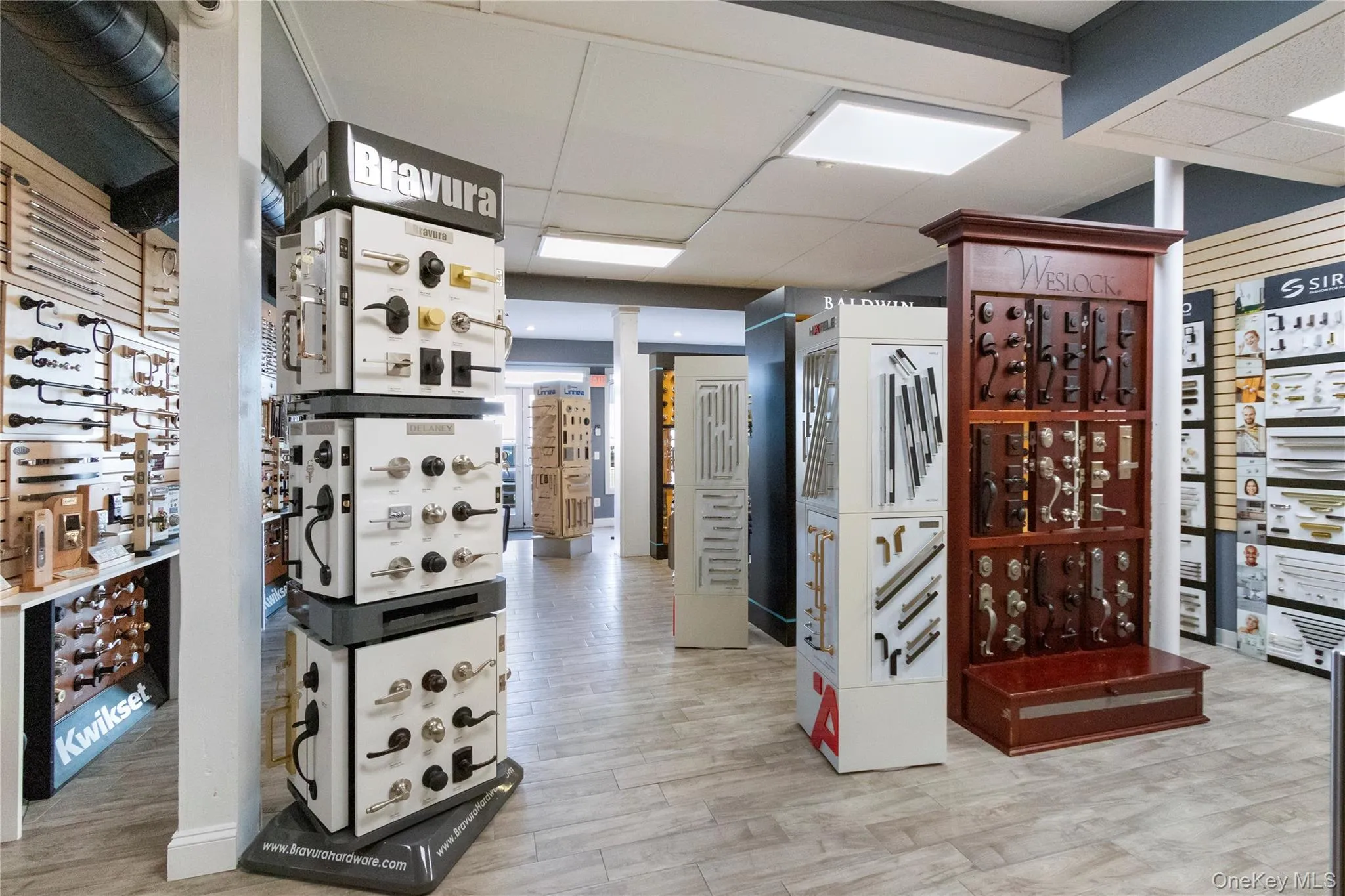Wine cellar with a paneled ceiling and light wood-type flooring Wine cellar with a paneled ceiling and light wood-type flooring