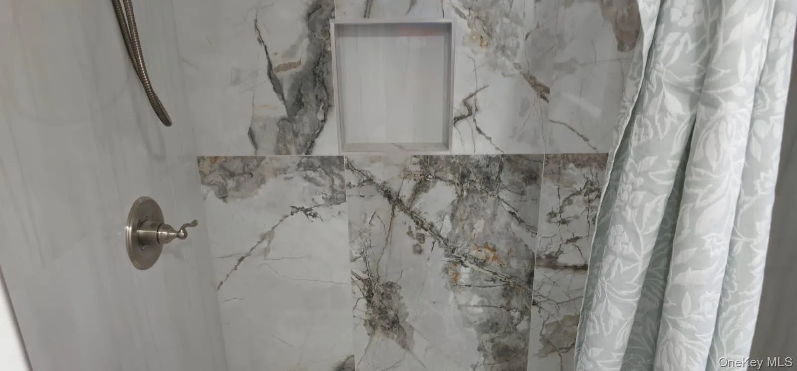 Bathroom view of a marble finish shower Bathroom view of a marble finish shower